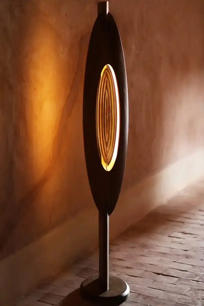 SALU IWADI GELEDE LAMP COLLECTION An image describing the Gelede lamp collection by Salu Iwadi Studio. The text details the materials and cultural meaning behind three lamp models. (image 8 of 11)