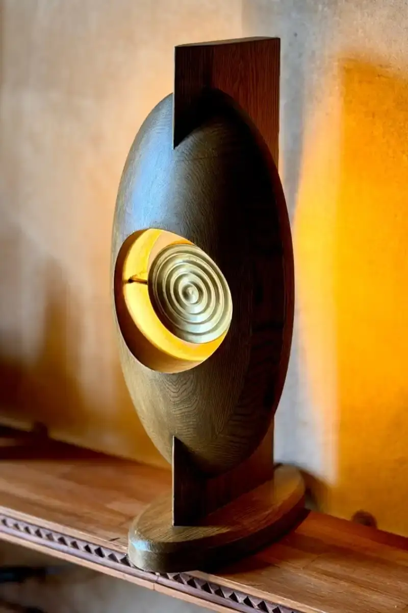 SALU IWADI GELEDE LAMP COLLECTION An image describing the Gelede lamp collection by Salu Iwadi Studio. The text details the materials and cultural meaning behind three lamp models. (image 10 of 11)