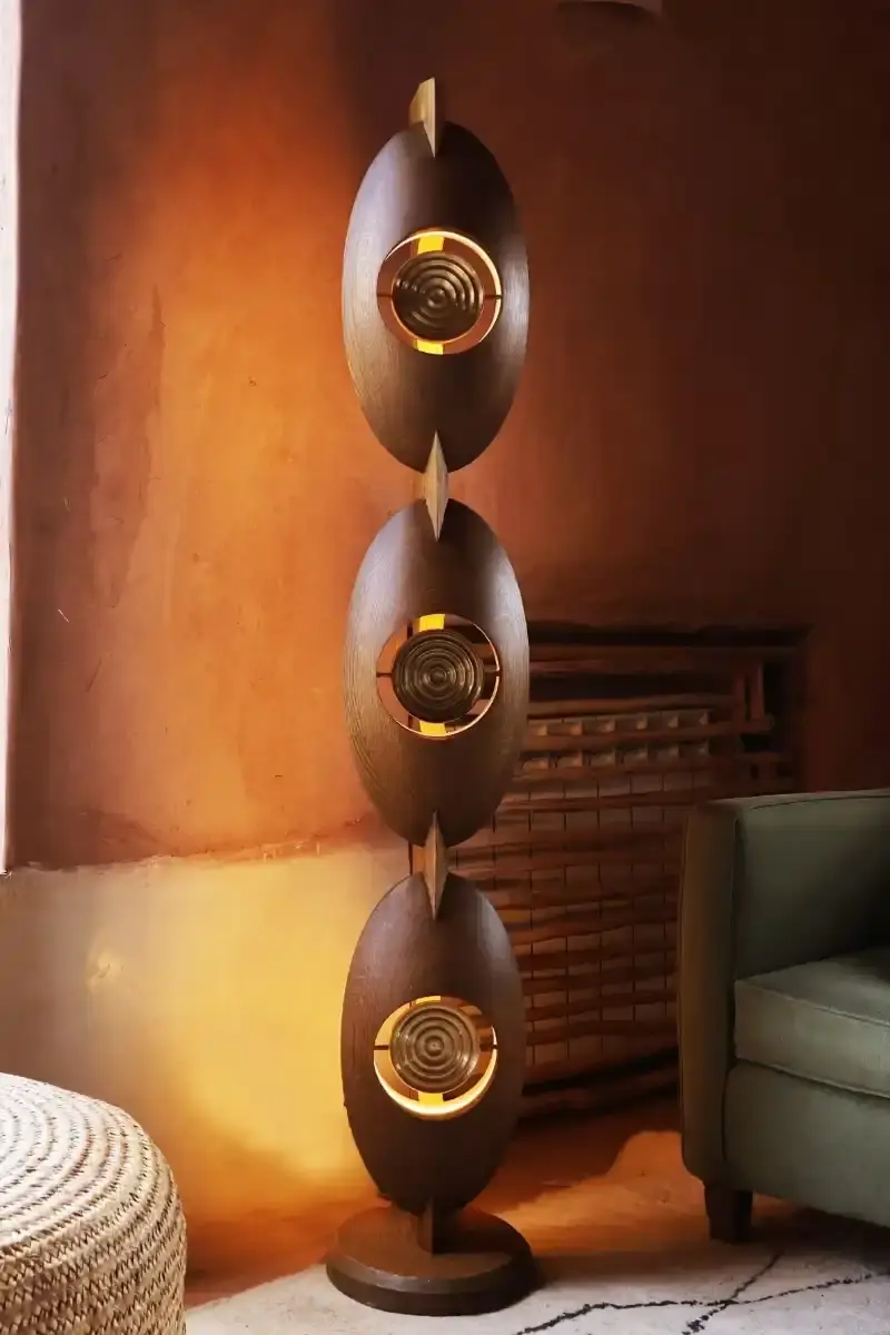 SALU IWADI GELEDE LAMP COLLECTION An image describing the Gelede lamp collection by Salu Iwadi Studio. The text details the materials and cultural meaning behind three lamp models. (image 5 of 11)