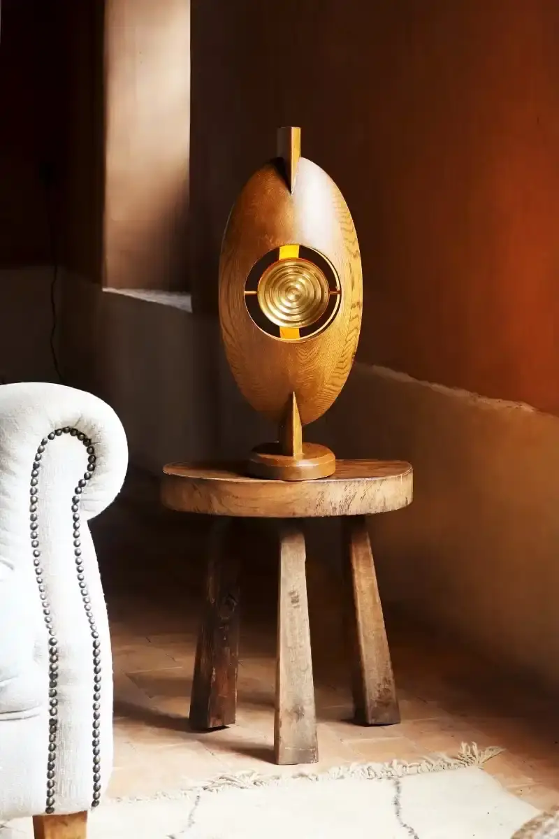 SALU IWADI GELEDE LAMP COLLECTION An image describing the Gelede lamp collection by Salu Iwadi Studio. The text details the materials and cultural meaning behind three lamp models. (image 9 of 11)