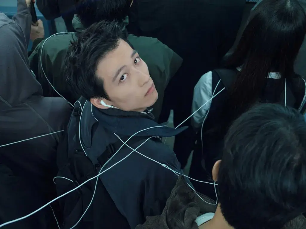 SAN SAN GEAR RELEASES 2026 CABLE COLLECTION A campaign photo shows a model tied in white cords over black outerwear alongside another model looking back in white technical strings.