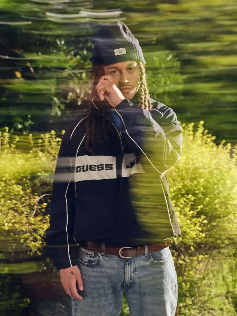 SAYF AND CLARA FRONT GUESS JEANS PRE FALL 2026 An IMAGE detailing the GUESS JEANS Pre Fall 2026 fashion campaign featuring musical artists Sayf and Clara in Milan. (image 3 of 6)