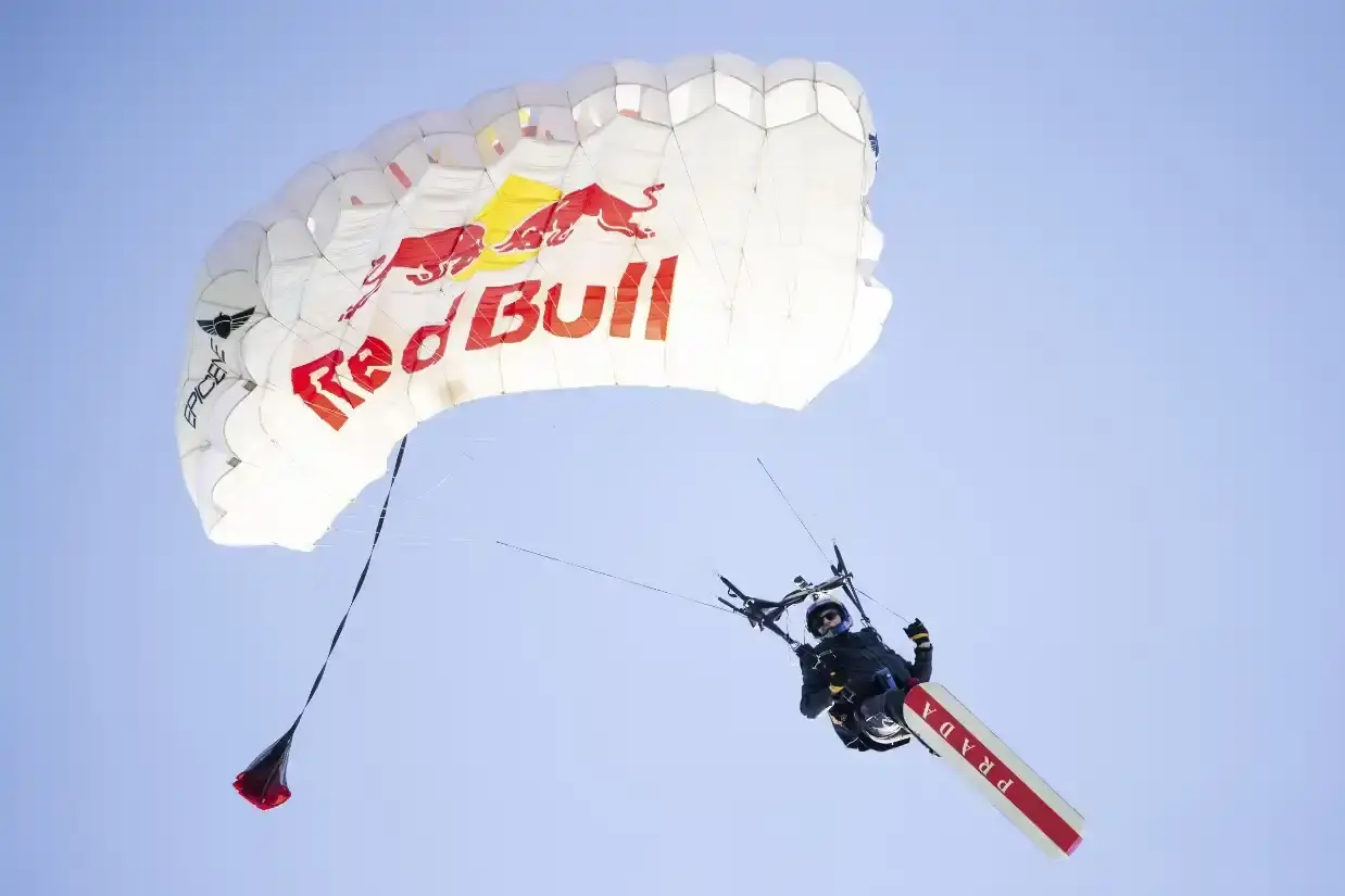 SKYSURFER MAKES HISTORY ON BAY BRIDGE WEARING PRADA image of Professional skysurfer Sean MacCormac performs historic stunt gliding across San Francisco Bay Bridge cables after helicopter jump, supported by Prada Linea Rossa and Red Bull partnership. (image 2 of 3)