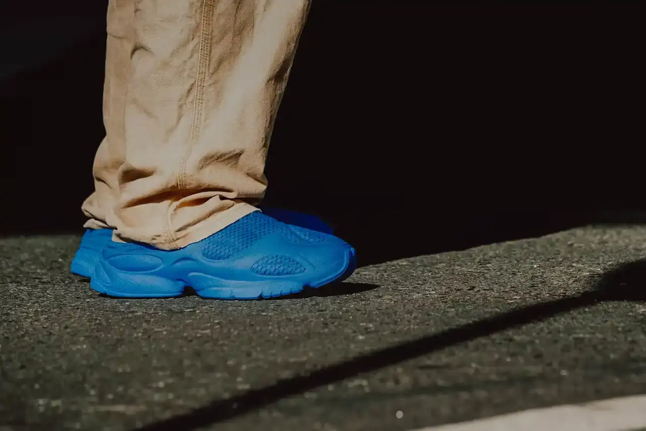 WOTHERSPOON PARTNERS WITH ZELLERFELD ON CUSTOM 3D SHOES image about fashion designer Sean Wotherspoon's collaboration with 3D printing company Zellerfeld to create a two-piece footwear collection called "Sean Double U." The piece discusses the custom manufacturing process, pricing, and design philosophy behind the sneaker and mule styles. Content includes quotes from Wotherspoon and details about the sustainable production methods used. (image 2 of 6)