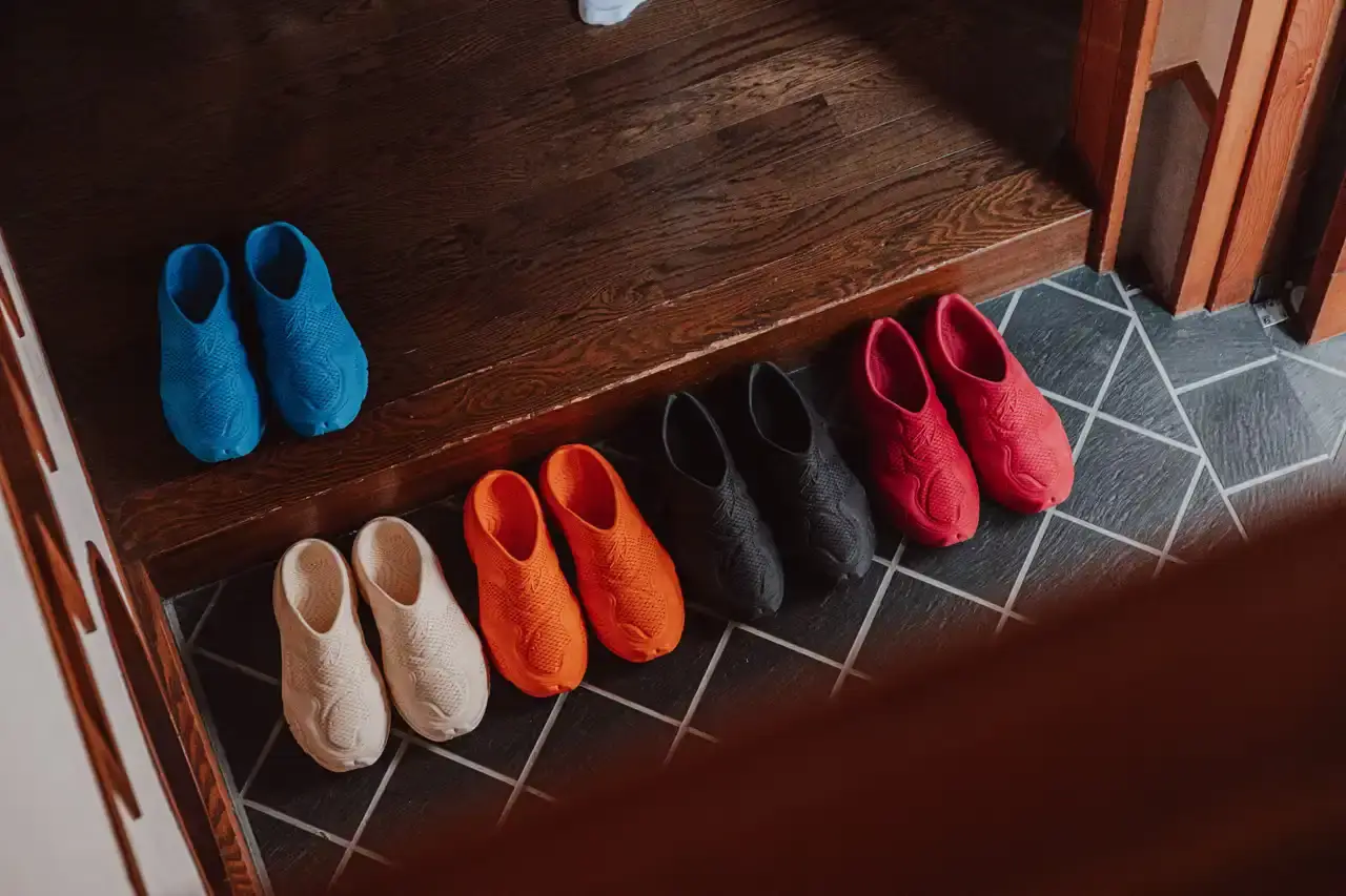WOTHERSPOON PARTNERS WITH ZELLERFELD ON CUSTOM 3D SHOES image about fashion designer Sean Wotherspoon's collaboration with 3D printing company Zellerfeld to create a two-piece footwear collection called "Sean Double U." The piece discusses the custom manufacturing process, pricing, and design philosophy behind the sneaker and mule styles. Content includes quotes from Wotherspoon and details about the sustainable production methods used. (image 5 of 6)