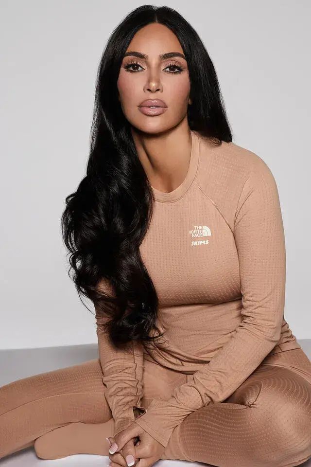 Skims/The North Face Kim Kardashian wearing SKIMS x The North Face Dot Knit Top and Bottom in neutral earth tones, photographed by Donna Trope against a minimalist background