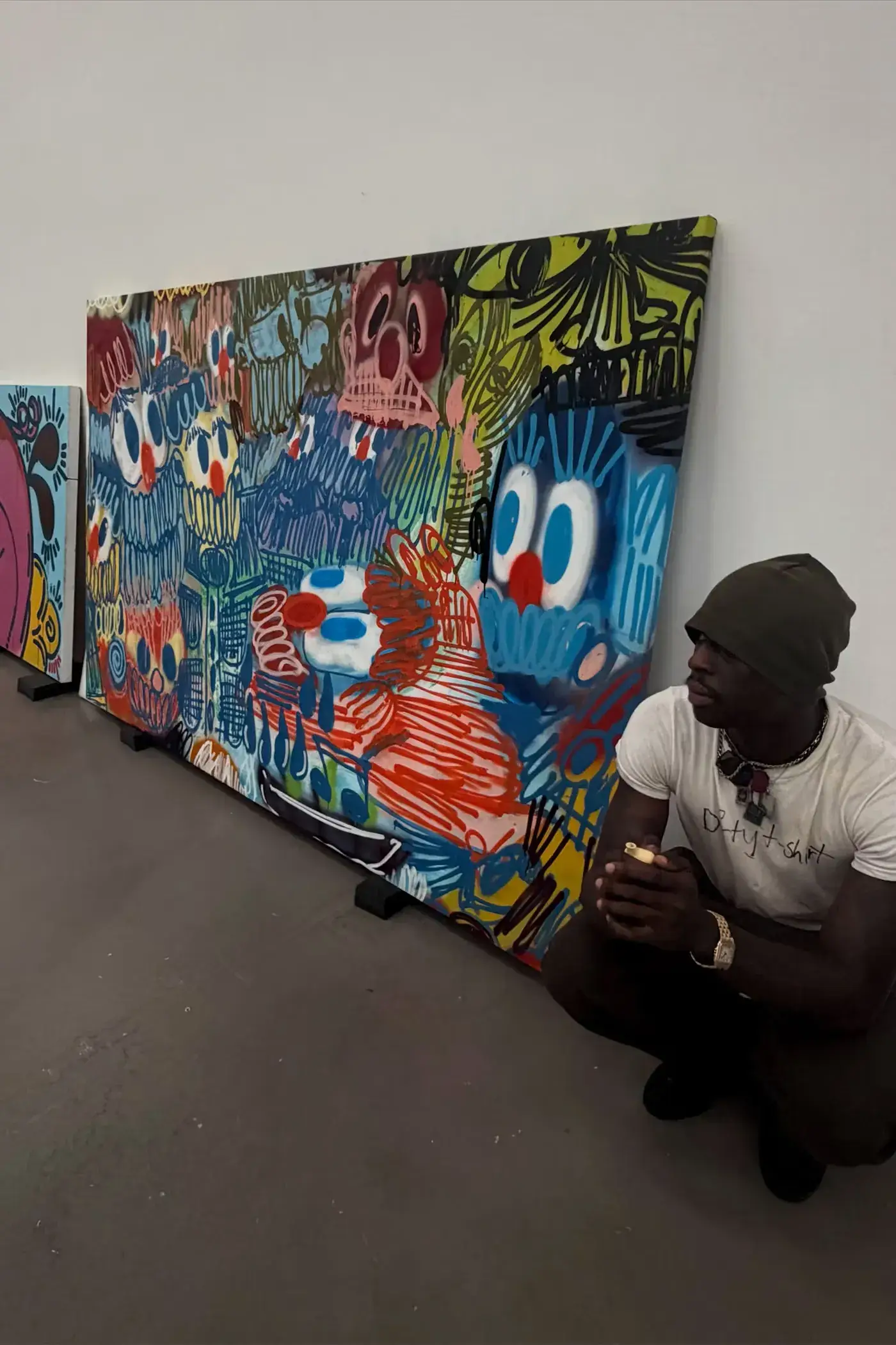 SLAWN EXHIBITION OPENS IN CHELSEA NEW YORK image description detailing London artist Olaolu Slawn's debut New York pop up art exhibition including large scale paintings and sportswear apparel. (image 4 of 14)