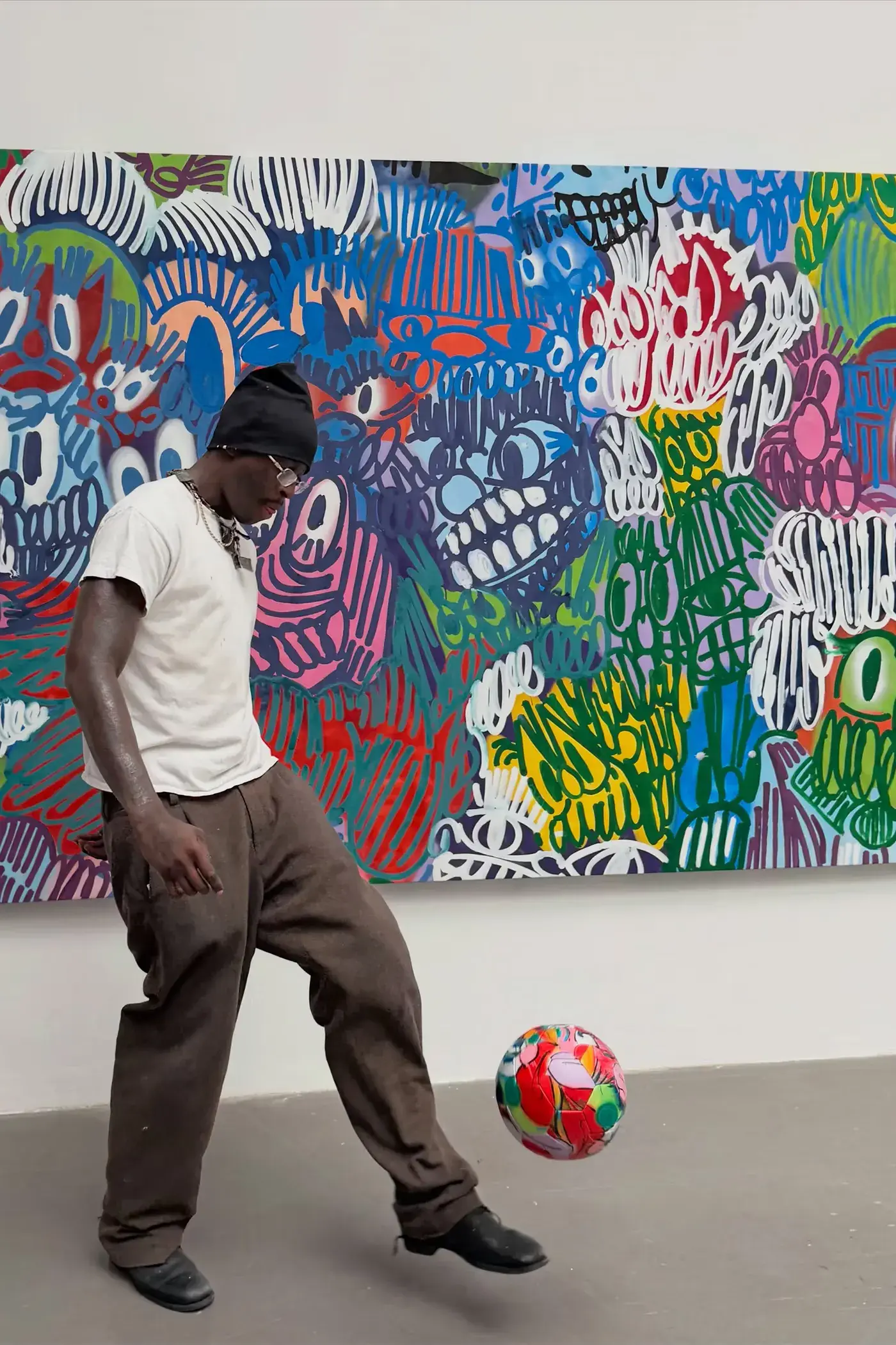 SLAWN EXHIBITION OPENS IN CHELSEA NEW YORK image description detailing London artist Olaolu Slawn's debut New York pop up art exhibition including large scale paintings and sportswear apparel.