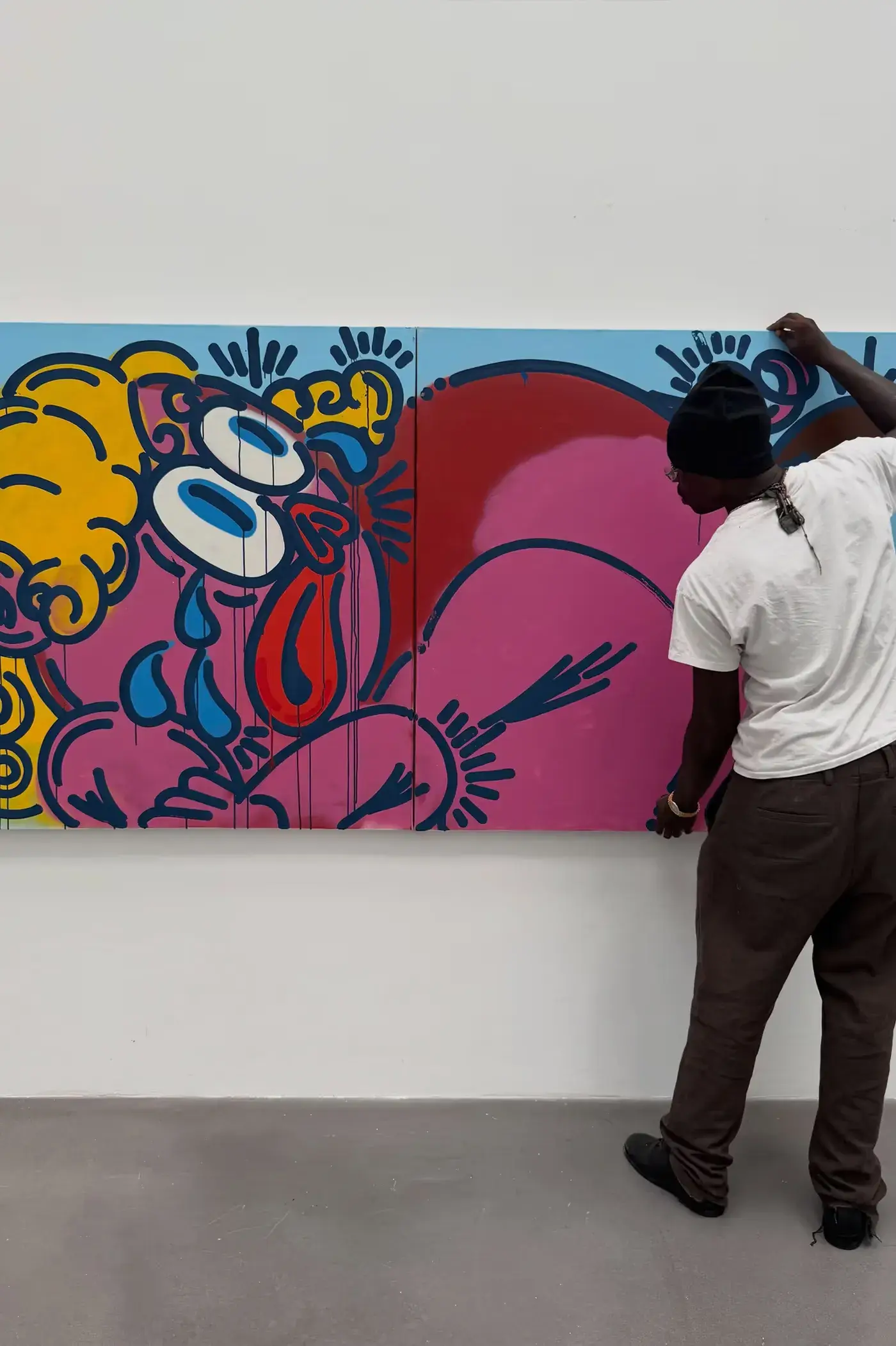 SLAWN EXHIBITION OPENS IN CHELSEA NEW YORK image description detailing London artist Olaolu Slawn's debut New York pop up art exhibition including large scale paintings and sportswear apparel. (image 5 of 14)