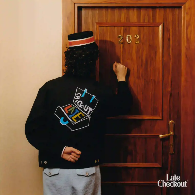 Late Checkout A collage of clothing pieces from Late Checkout's Hotel Games collection, featuring relaxed summer styles with subtle workwear influences. Models wearing collegiate-inspired designs with hotel-themed graphics, showcasing pieces that blend comfort and playful design against a minimalist background. (image 9 of 9)