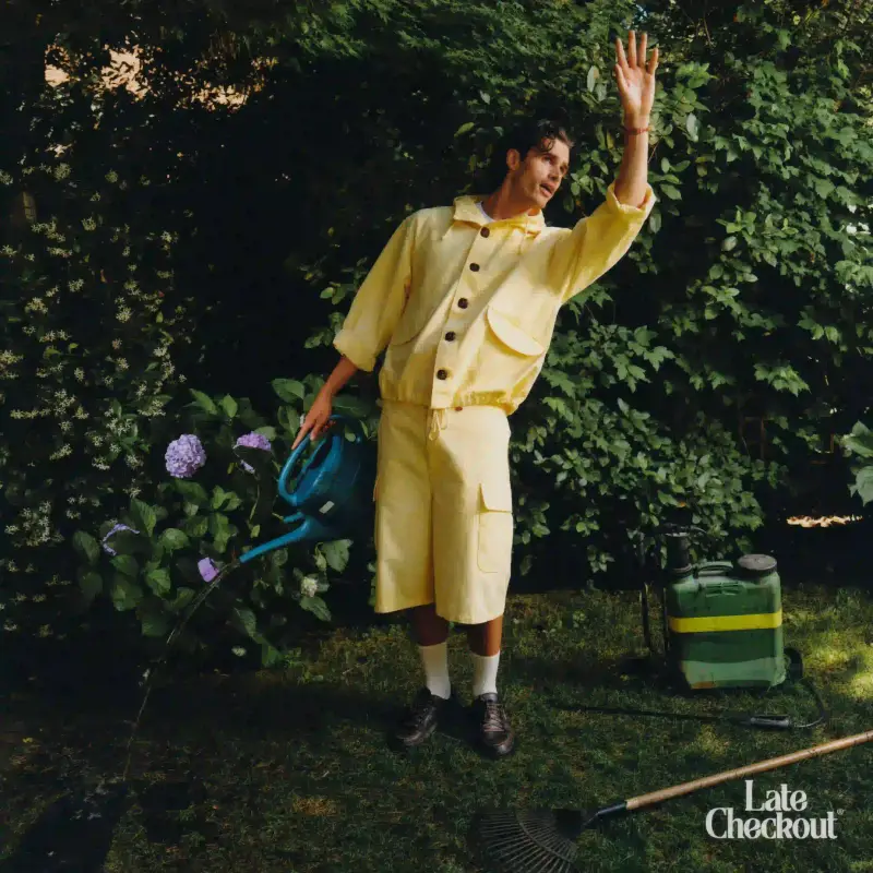 Late Checkout A collage of clothing pieces from Late Checkout's Hotel Games collection, featuring relaxed summer styles with subtle workwear influences. Models wearing collegiate-inspired designs with hotel-themed graphics, showcasing pieces that blend comfort and playful design against a minimalist background. (image 4 of 9)
