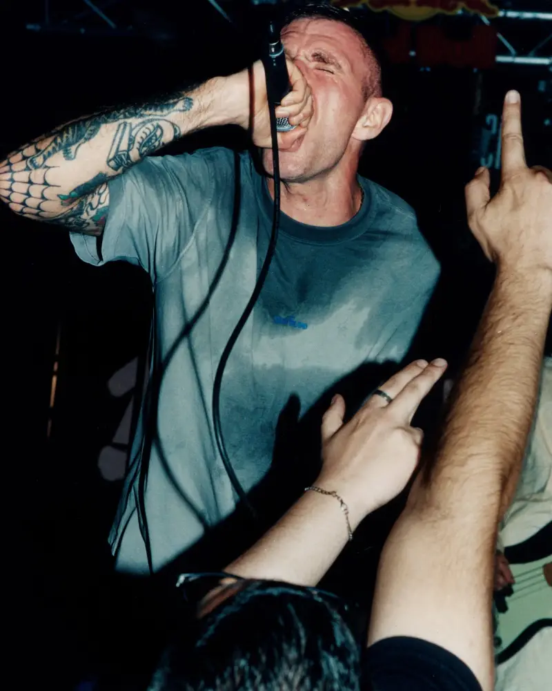 STONE ISLAND HARDCORE SUBCULTURE PROJECT image of photograph collection detailing musicians wearing vintage and modern Stone Island outerwear on tour across North America and Europe. (image 3 of 8)