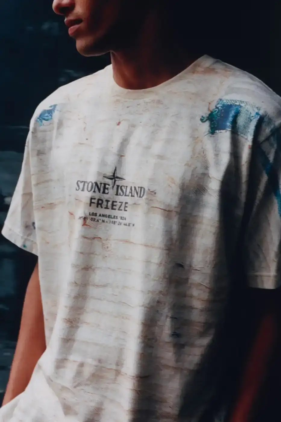 STONE ISLAND JAMAL CYRUS FRIEZE LA 2026 SHIRT A white t-shirt featuring black and grey abstract digital prints inspired by archival documents and historical collage. (image 4 of 6)