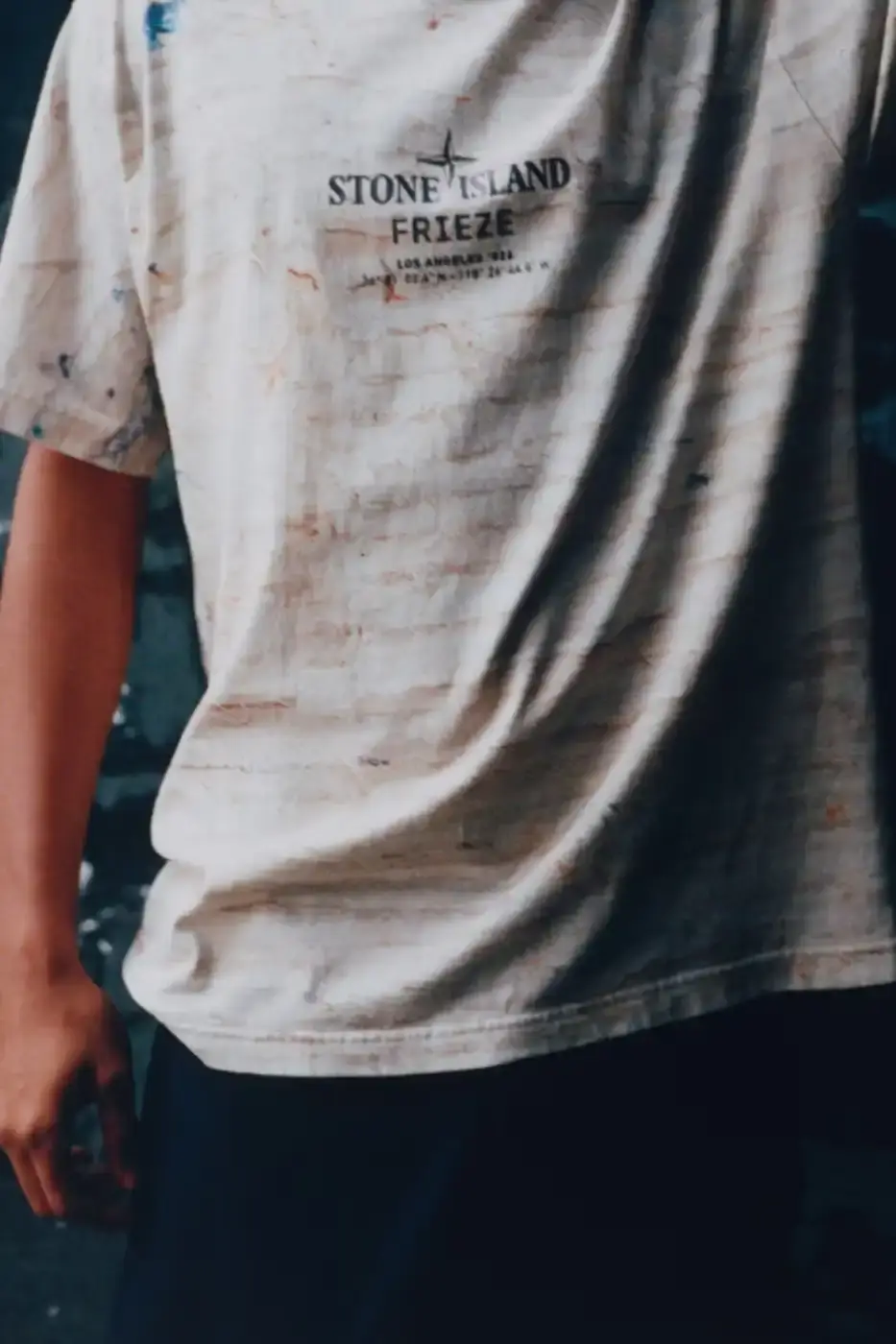 STONE ISLAND JAMAL CYRUS FRIEZE LA 2026 SHIRT A white t-shirt featuring black and grey abstract digital prints inspired by archival documents and historical collage. (image 3 of 6)