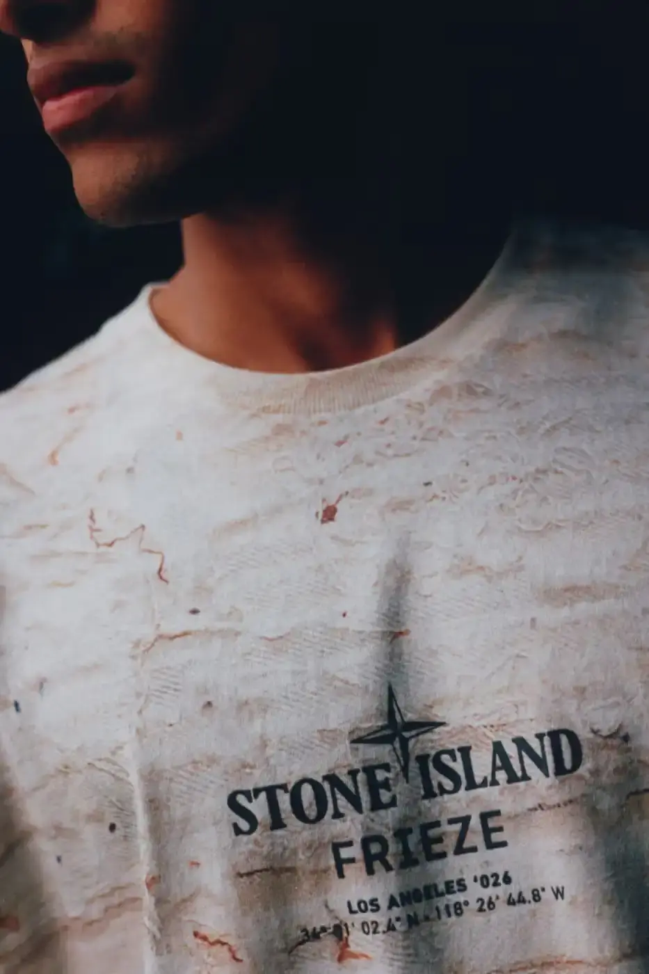 STONE ISLAND JAMAL CYRUS FRIEZE LA 2026 SHIRT A white t-shirt featuring black and grey abstract digital prints inspired by archival documents and historical collage. (image 2 of 6)
