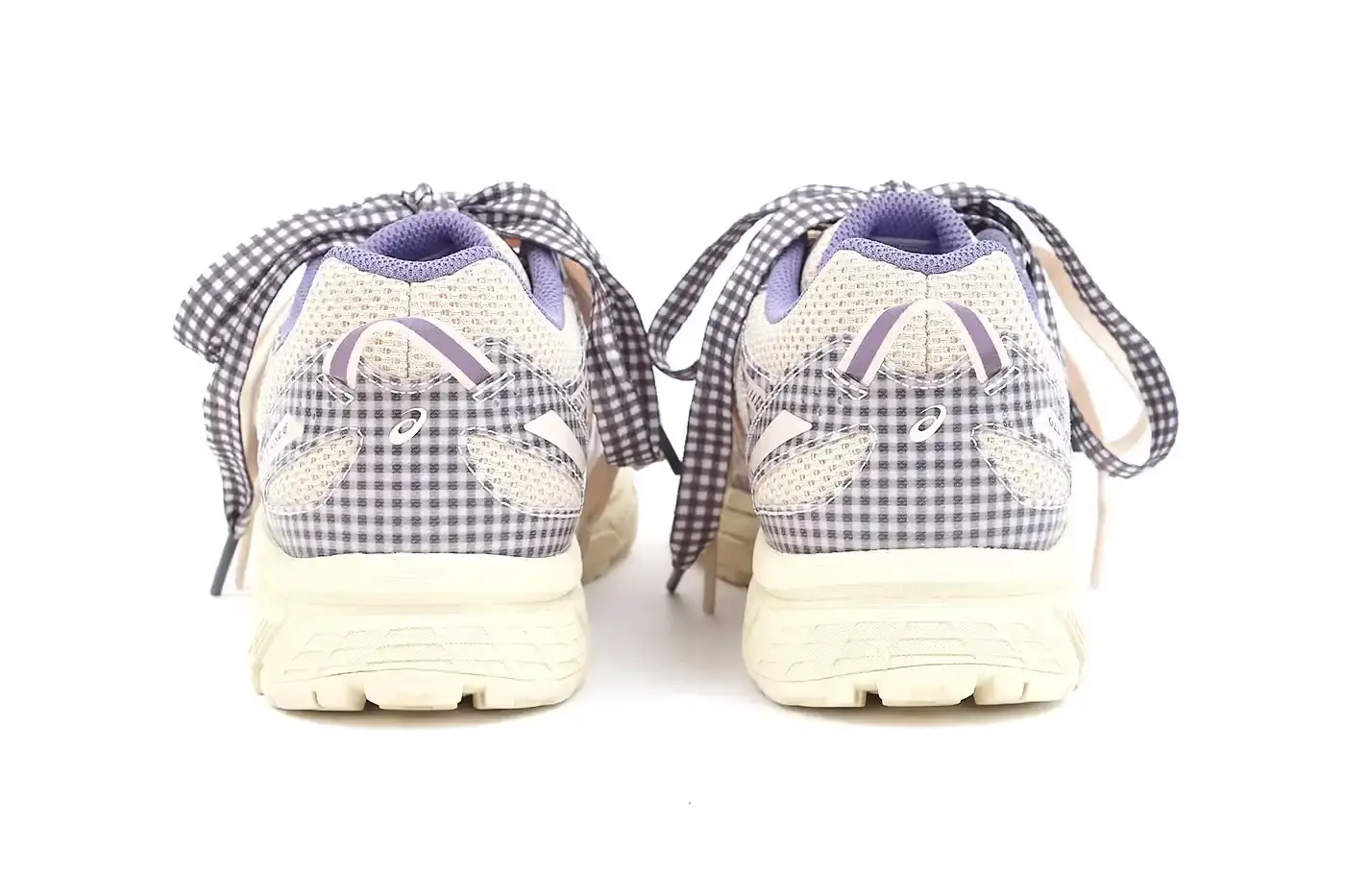 ASICS GEL-VENTURE 6 GETS GINGHAM MAKEOVER FROM STORY MFG. photo of the collaboration between sustainable fashion brand STORY mfg. and ASICS on the GEL-VENTURE 6 sneaker. It details the two gingham colorways ("Reddish Brown" and "Vanilla Violet Quartz"), the unique woven lacing system inspired by Baghdad skaters, and pricing ($133 USD). The article also describes the two-day launch event at The Truman Brewery in London on April 18-19, where visitors can contribute embroidery to a community art project while enjoying refreshments. The article provides purchase information and explains STORY mfg.'s sustainable fashion background. (image 13 of 14)