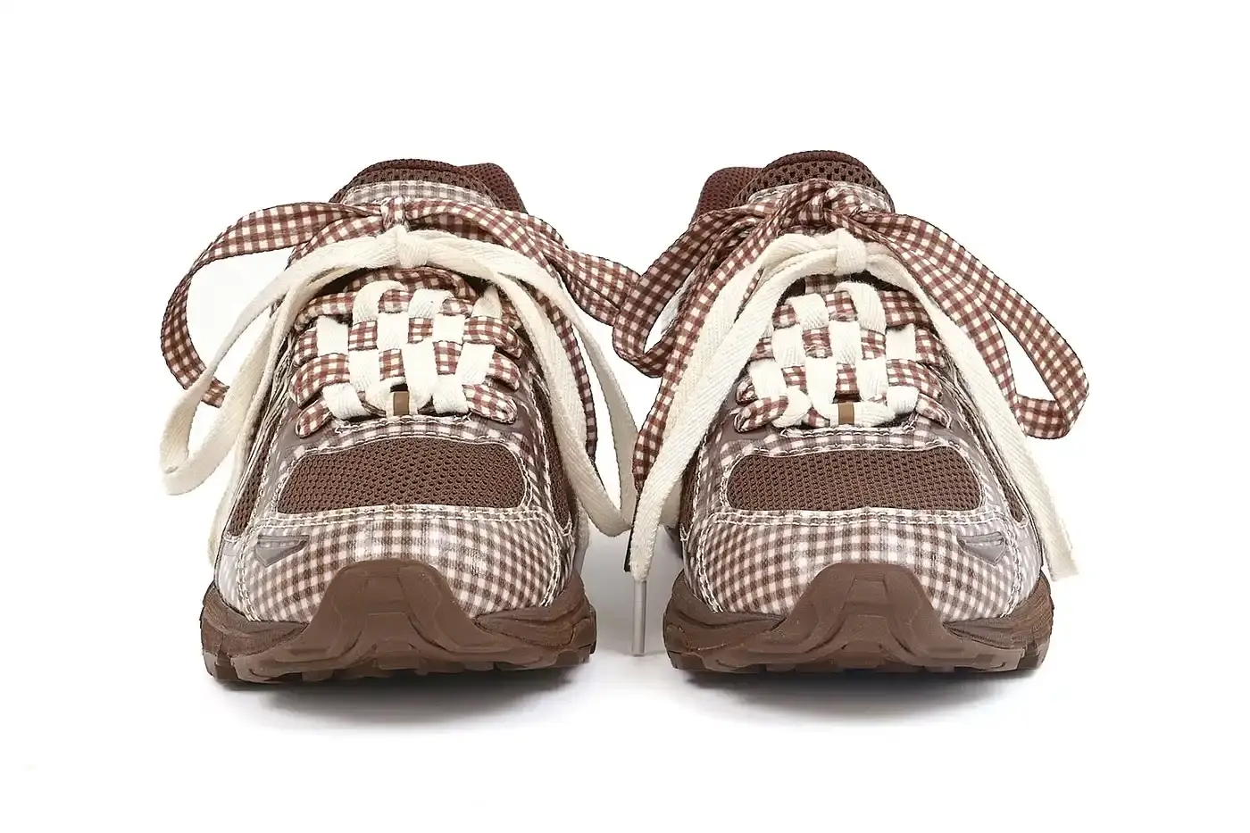 ASICS GEL-VENTURE 6 GETS GINGHAM MAKEOVER FROM STORY MFG. photo of the collaboration between sustainable fashion brand STORY mfg. and ASICS on the GEL-VENTURE 6 sneaker. It details the two gingham colorways ("Reddish Brown" and "Vanilla Violet Quartz"), the unique woven lacing system inspired by Baghdad skaters, and pricing ($133 USD). The article also describes the two-day launch event at The Truman Brewery in London on April 18-19, where visitors can contribute embroidery to a community art project while enjoying refreshments. The article provides purchase information and explains STORY mfg.'s sustainable fashion background. (image 6 of 14)
