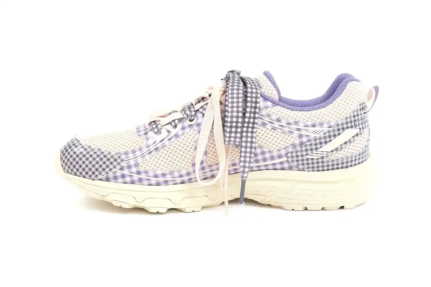ASICS GEL-VENTURE 6 GETS GINGHAM MAKEOVER FROM STORY MFG. photo of the collaboration between sustainable fashion brand STORY mfg. and ASICS on the GEL-VENTURE 6 sneaker. It details the two gingham colorways ("Reddish Brown" and "Vanilla Violet Quartz"), the unique woven lacing system inspired by Baghdad skaters, and pricing ($133 USD). The article also describes the two-day launch event at The Truman Brewery in London on April 18-19, where visitors can contribute embroidery to a community art project while enjoying refreshments. The article provides purchase information and explains STORY mfg.'s sustainable fashion background. (image 10 of 14)