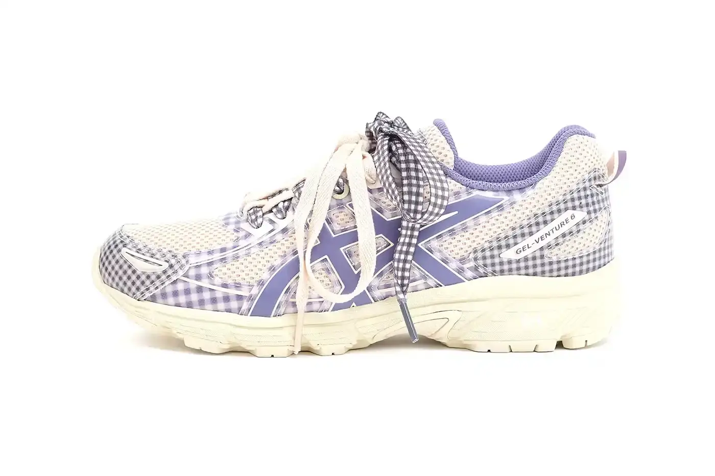 ASICS GEL-VENTURE 6 GETS GINGHAM MAKEOVER FROM STORY MFG. photo of the collaboration between sustainable fashion brand STORY mfg. and ASICS on the GEL-VENTURE 6 sneaker. It details the two gingham colorways ("Reddish Brown" and "Vanilla Violet Quartz"), the unique woven lacing system inspired by Baghdad skaters, and pricing ($133 USD). The article also describes the two-day launch event at The Truman Brewery in London on April 18-19, where visitors can contribute embroidery to a community art project while enjoying refreshments. The article provides purchase information and explains STORY mfg.'s sustainable fashion background. (image 9 of 14)