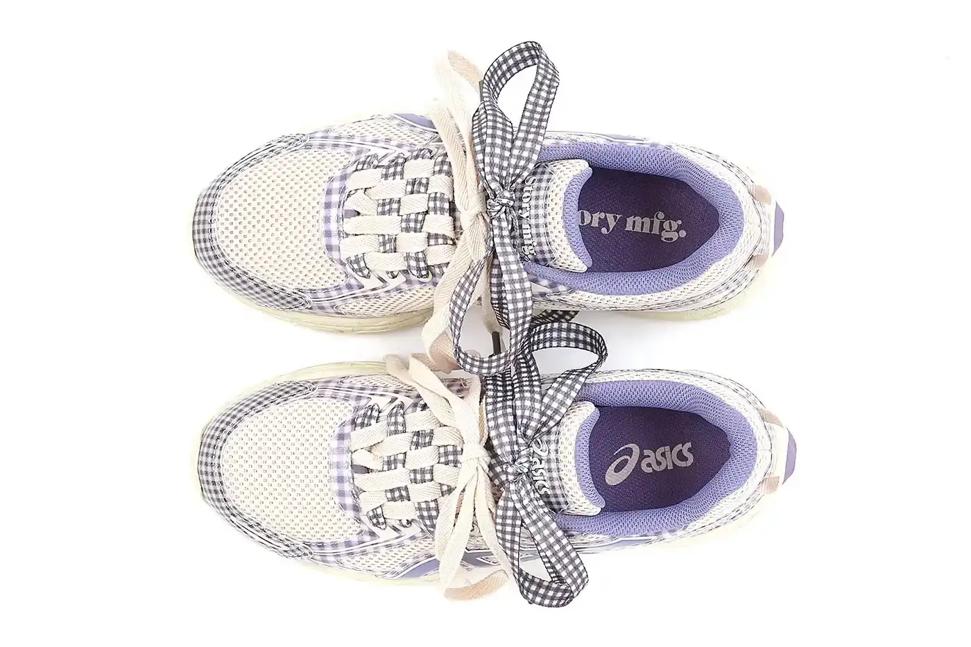 ASICS GEL-VENTURE 6 GETS GINGHAM MAKEOVER FROM STORY MFG. photo of the collaboration between sustainable fashion brand STORY mfg. and ASICS on the GEL-VENTURE 6 sneaker. It details the two gingham colorways ("Reddish Brown" and "Vanilla Violet Quartz"), the unique woven lacing system inspired by Baghdad skaters, and pricing ($133 USD). The article also describes the two-day launch event at The Truman Brewery in London on April 18-19, where visitors can contribute embroidery to a community art project while enjoying refreshments. The article provides purchase information and explains STORY mfg.'s sustainable fashion background. (image 12 of 14)