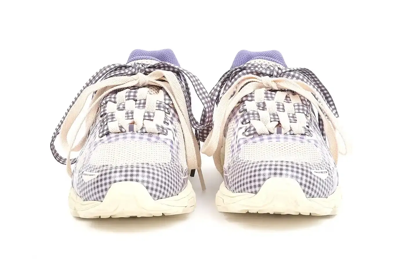 ASICS GEL-VENTURE 6 GETS GINGHAM MAKEOVER FROM STORY MFG. photo of the collaboration between sustainable fashion brand STORY mfg. and ASICS on the GEL-VENTURE 6 sneaker. It details the two gingham colorways ("Reddish Brown" and "Vanilla Violet Quartz"), the unique woven lacing system inspired by Baghdad skaters, and pricing ($133 USD). The article also describes the two-day launch event at The Truman Brewery in London on April 18-19, where visitors can contribute embroidery to a community art project while enjoying refreshments. The article provides purchase information and explains STORY mfg.'s sustainable fashion background. (image 11 of 14)