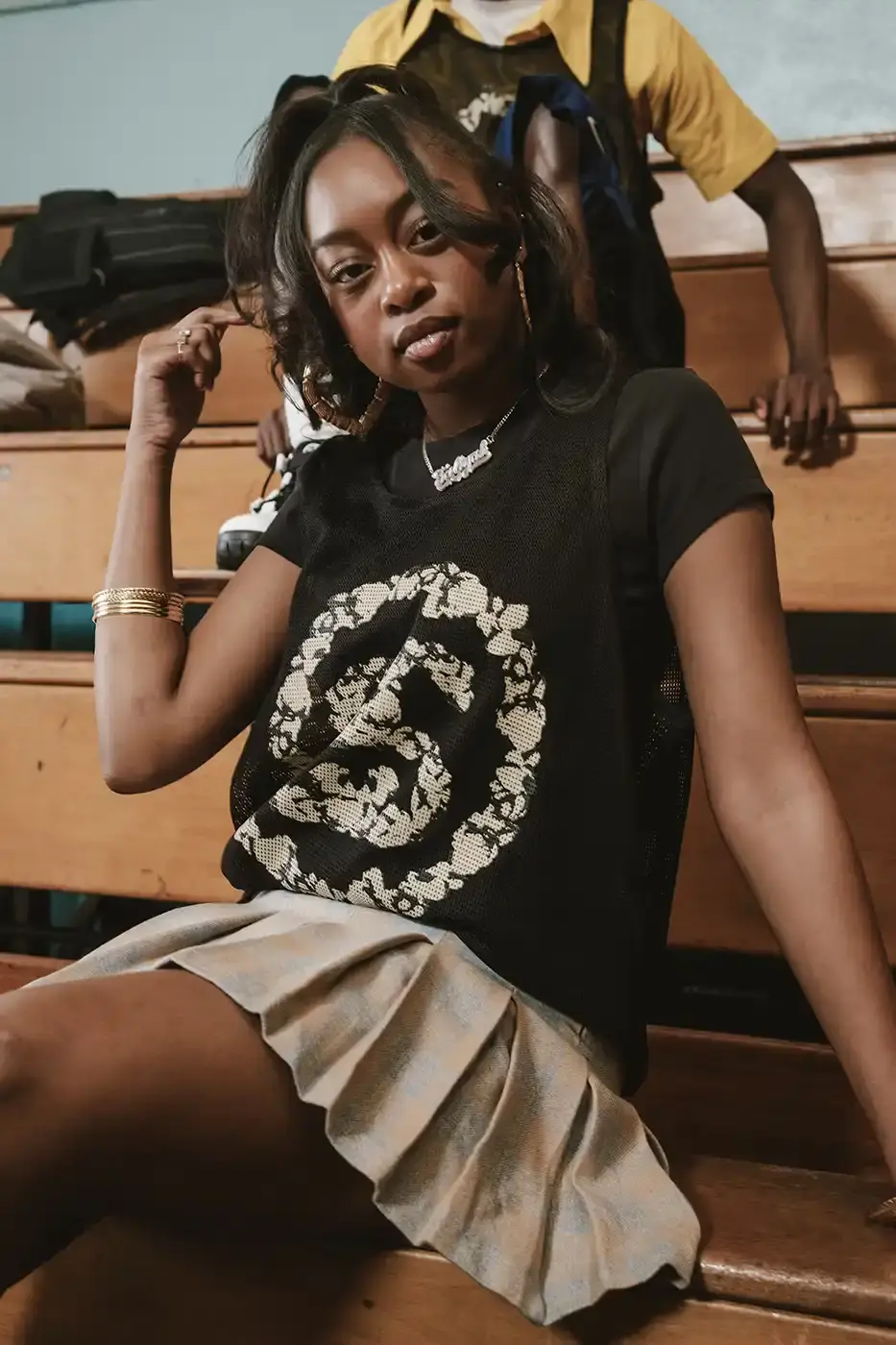 Stüssy/Denim Tears A display of Stüssy x Denim Tears' school-inspired collection, showing oxford shirts, blazers, and chinos arranged on a neutral background. The pieces feature co-branded designs and Pan-African American flag motifs. (image 5 of 11)