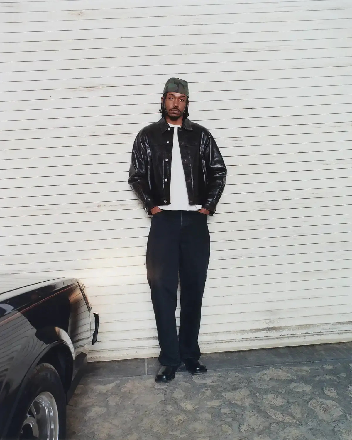 Model wearing Stüssy leather shearling coat and coordinated wool set from new collection