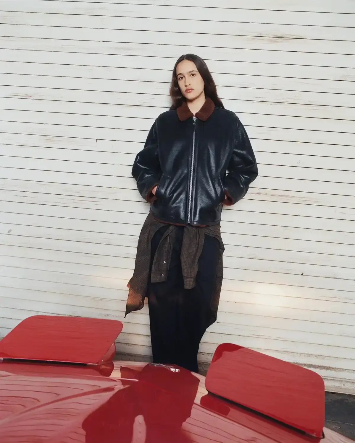 Model wearing Stüssy leather shearling coat and coordinated wool set from new collection (image 13 of 13)