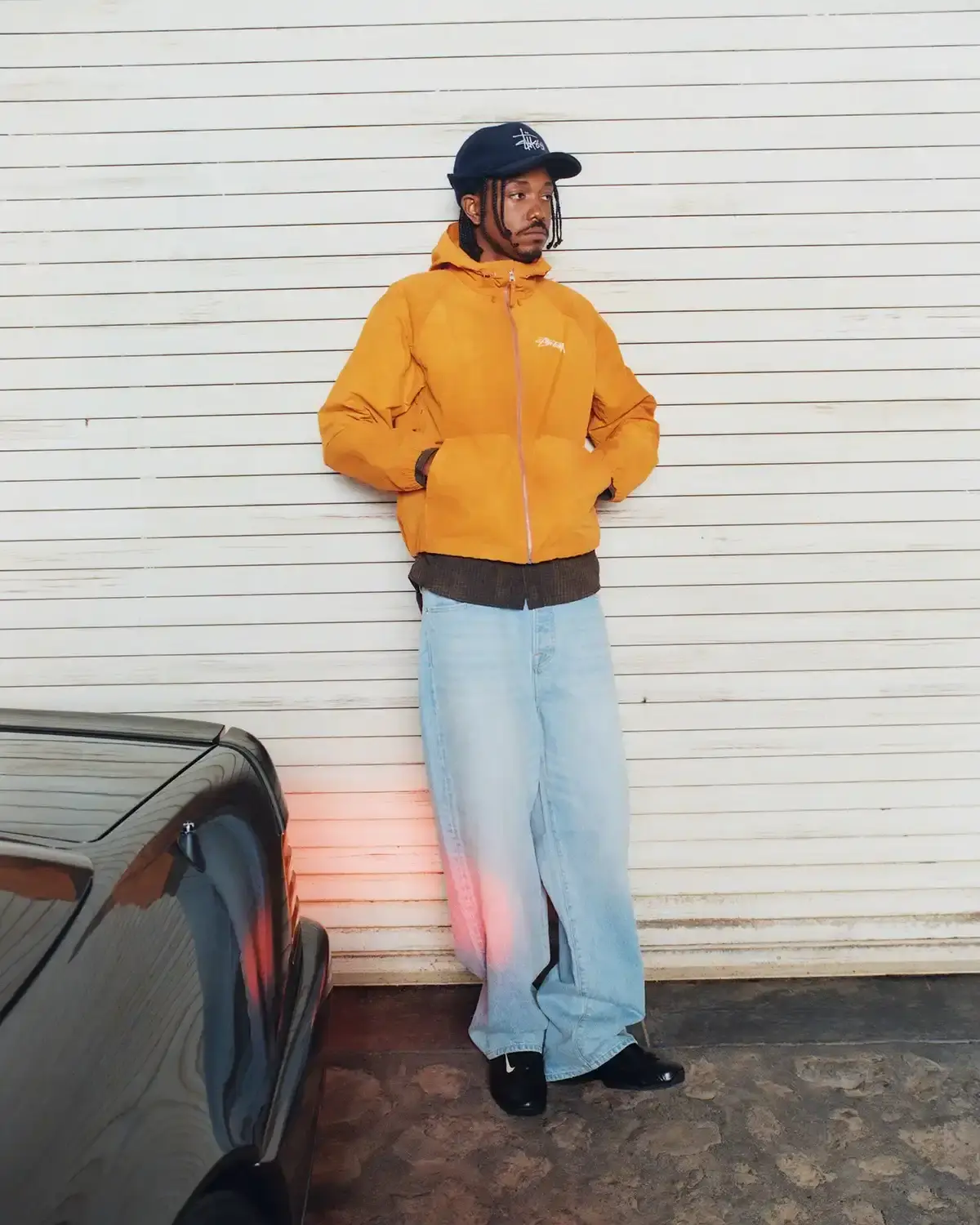 Model wearing Stüssy leather shearling coat and coordinated wool set from new collection (image 12 of 13)