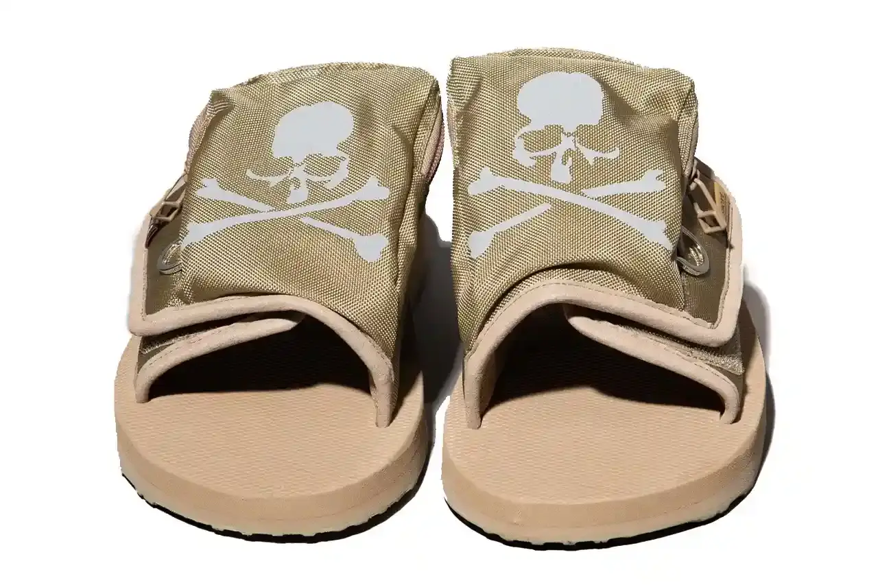 SUICOKE TEAMS UP WITH MASTERMIND JAPAN FOR NEW SANDALS Article about Japanese footwear collaboration between SUICOKE and mastermind JAPAN featuring reflective sandals with technical specifications, pricing, and availability details. Content includes brand background, product features, materials, and retail information. (image 6 of 6)