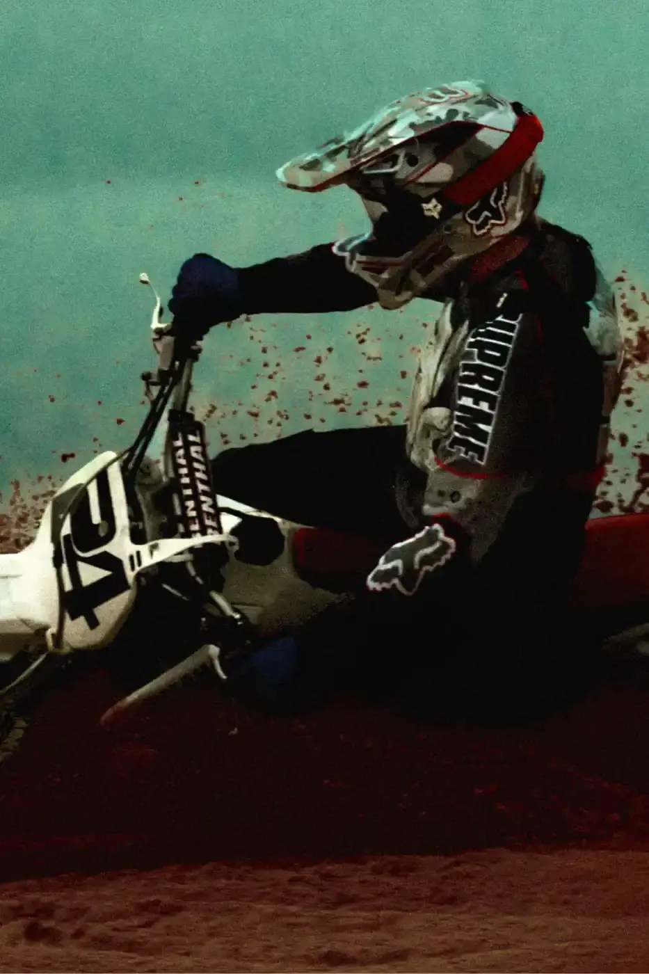SUPREME X FOX RACING FALL 2025 DROP Supreme collaborates with Fox Racing on a Fall 2025 collection that includes motorsport gear and apparel, featuring tribute pieces to DMX with racing jerseys, helmets, and protective gear in gray camo print with red accents. (image 6 of 26)