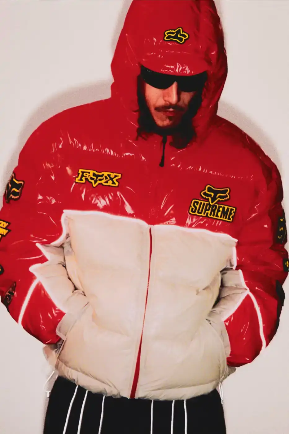 SUPREME X FOX RACING FALL 2025 DROP Supreme collaborates with Fox Racing on a Fall 2025 collection that includes motorsport gear and apparel, featuring tribute pieces to DMX with racing jerseys, helmets, and protective gear in gray camo print with red accents.