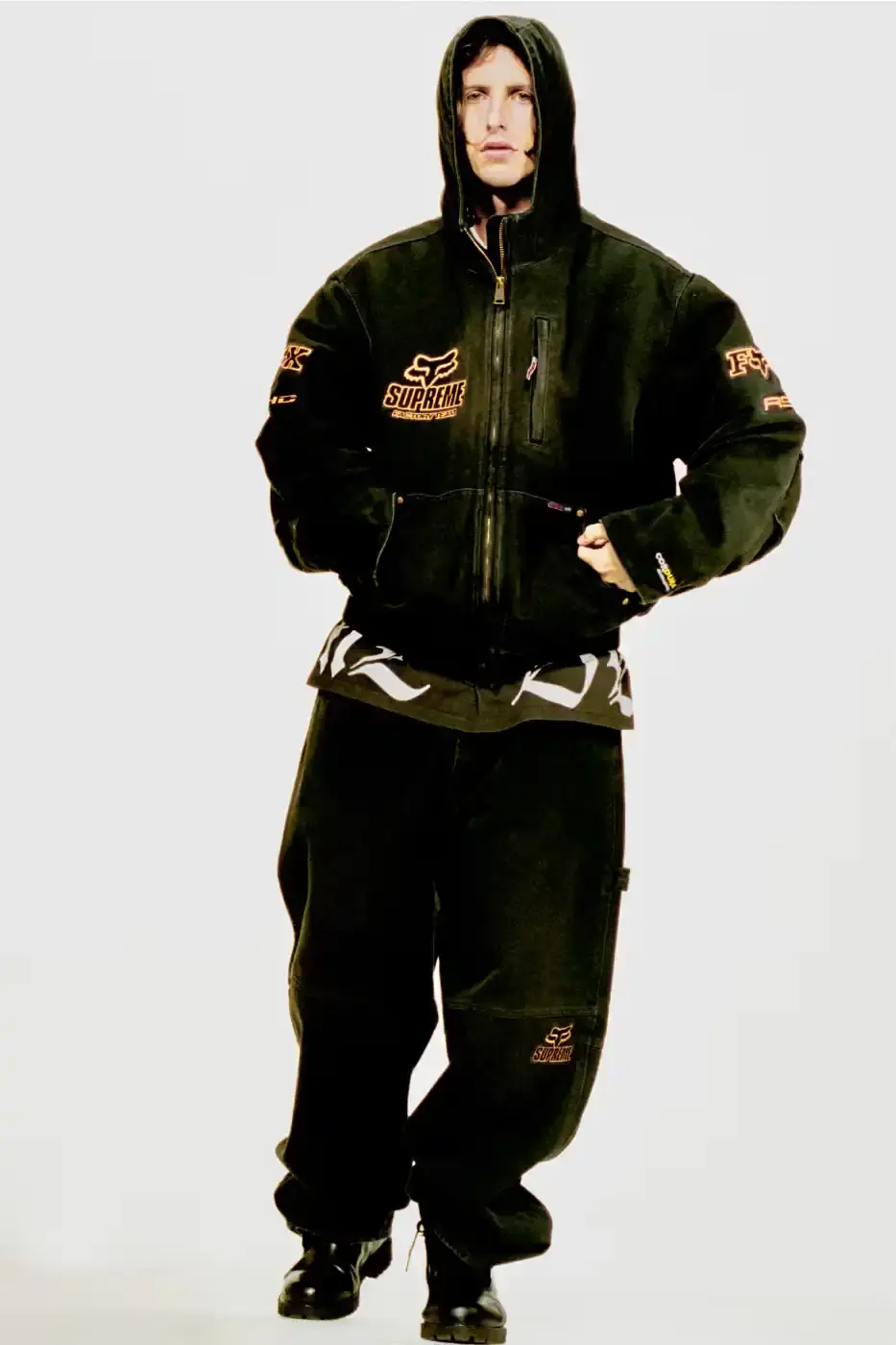 SUPREME X FOX RACING FALL 2025 DROP Supreme collaborates with Fox Racing on a Fall 2025 collection that includes motorsport gear and apparel, featuring tribute pieces to DMX with racing jerseys, helmets, and protective gear in gray camo print with red accents. (image 22 of 26)