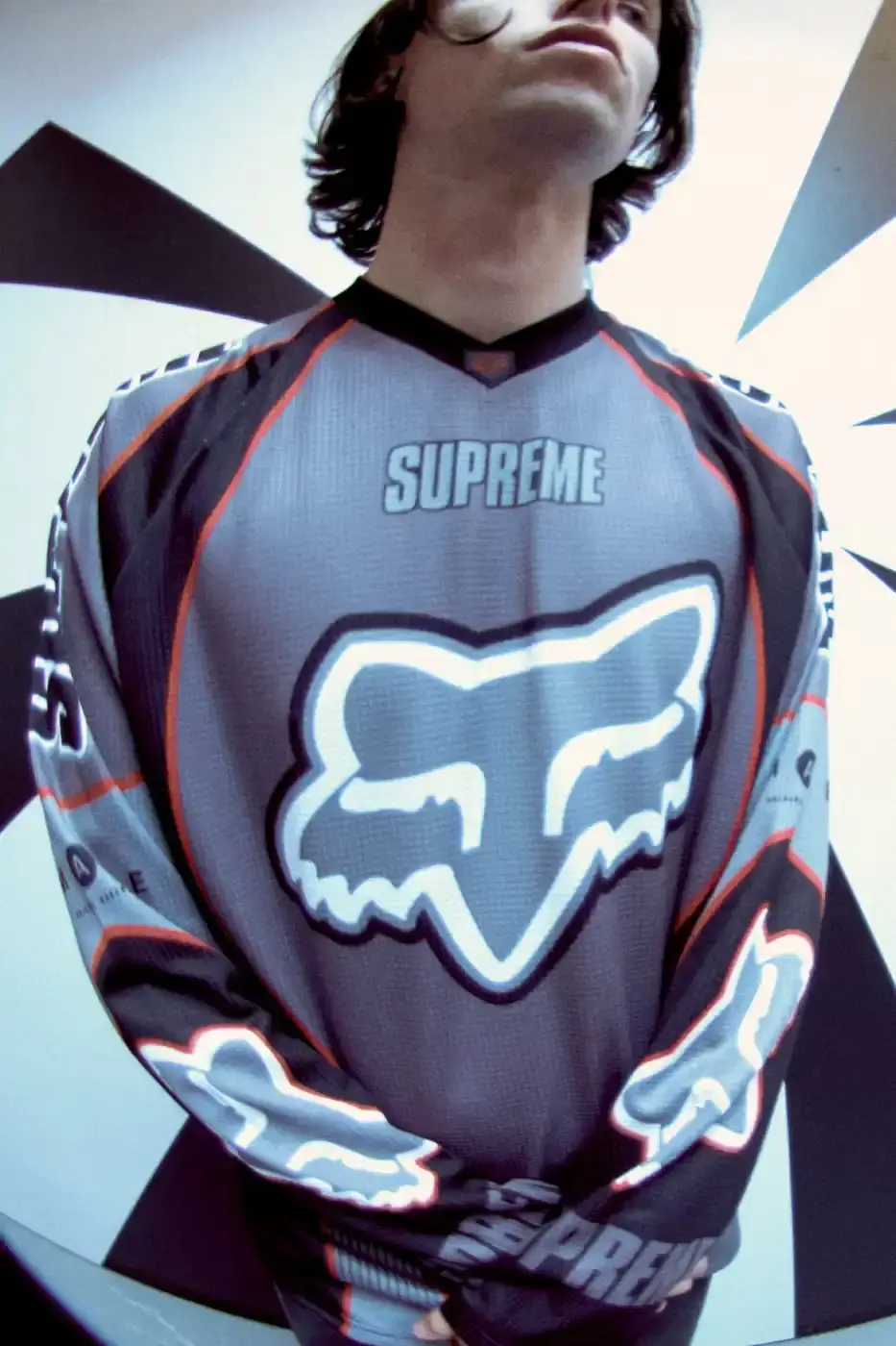 SUPREME X FOX RACING FALL 2025 DROP Supreme collaborates with Fox Racing on a Fall 2025 collection that includes motorsport gear and apparel, featuring tribute pieces to DMX with racing jerseys, helmets, and protective gear in gray camo print with red accents. (image 20 of 26)
