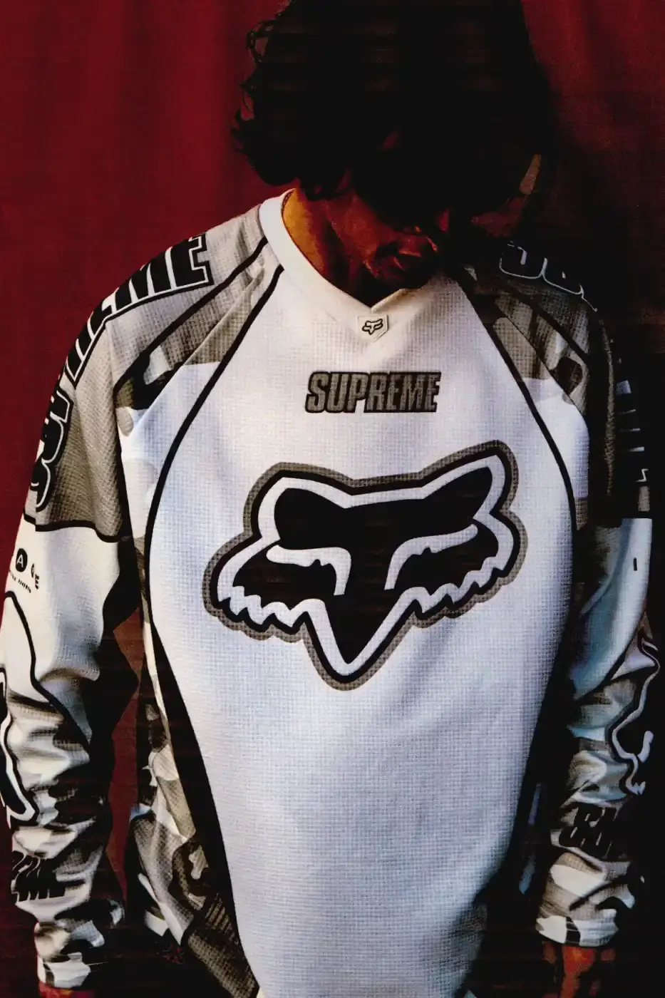 SUPREME X FOX RACING FALL 2025 DROP Supreme collaborates with Fox Racing on a Fall 2025 collection that includes motorsport gear and apparel, featuring tribute pieces to DMX with racing jerseys, helmets, and protective gear in gray camo print with red accents. (image 18 of 26)