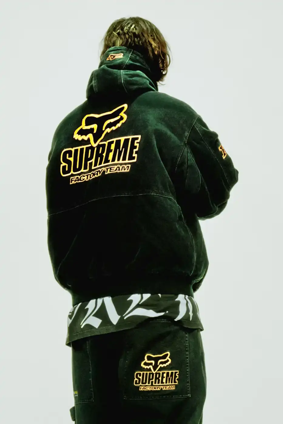 SUPREME X FOX RACING FALL 2025 DROP Supreme collaborates with Fox Racing on a Fall 2025 collection that includes motorsport gear and apparel, featuring tribute pieces to DMX with racing jerseys, helmets, and protective gear in gray camo print with red accents. (image 21 of 26)