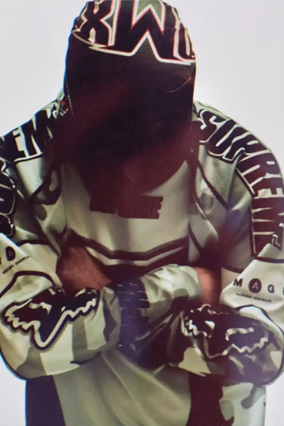 SUPREME X FOX RACING FALL 2025 DROP Supreme collaborates with Fox Racing on a Fall 2025 collection that includes motorsport gear and apparel, featuring tribute pieces to DMX with racing jerseys, helmets, and protective gear in gray camo print with red accents. (image 17 of 26)