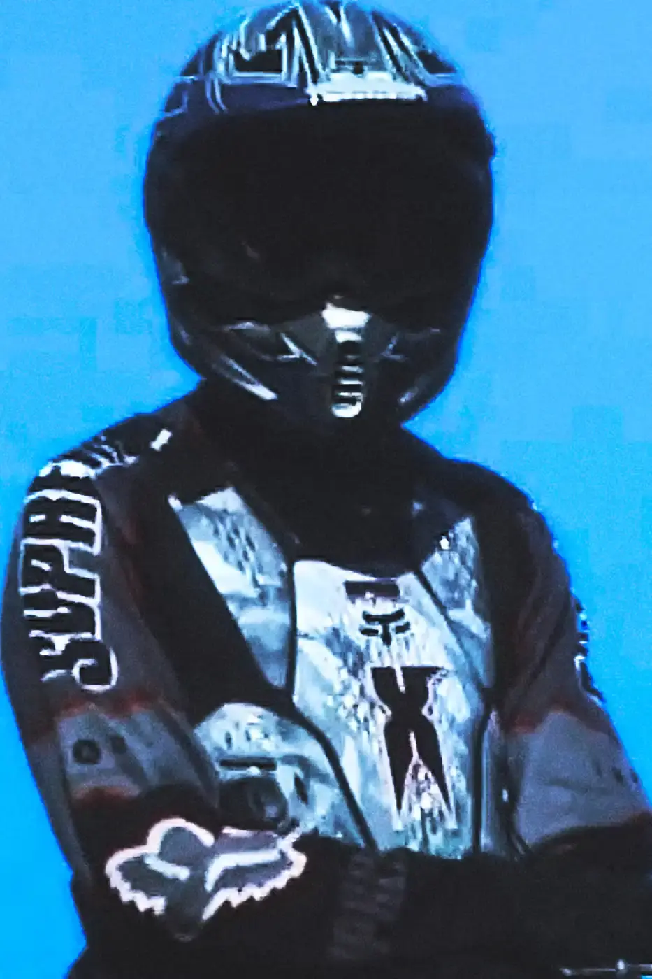 SUPREME X FOX RACING FALL 2025 DROP Supreme collaborates with Fox Racing on a Fall 2025 collection that includes motorsport gear and apparel, featuring tribute pieces to DMX with racing jerseys, helmets, and protective gear in gray camo print with red accents. (image 4 of 26)