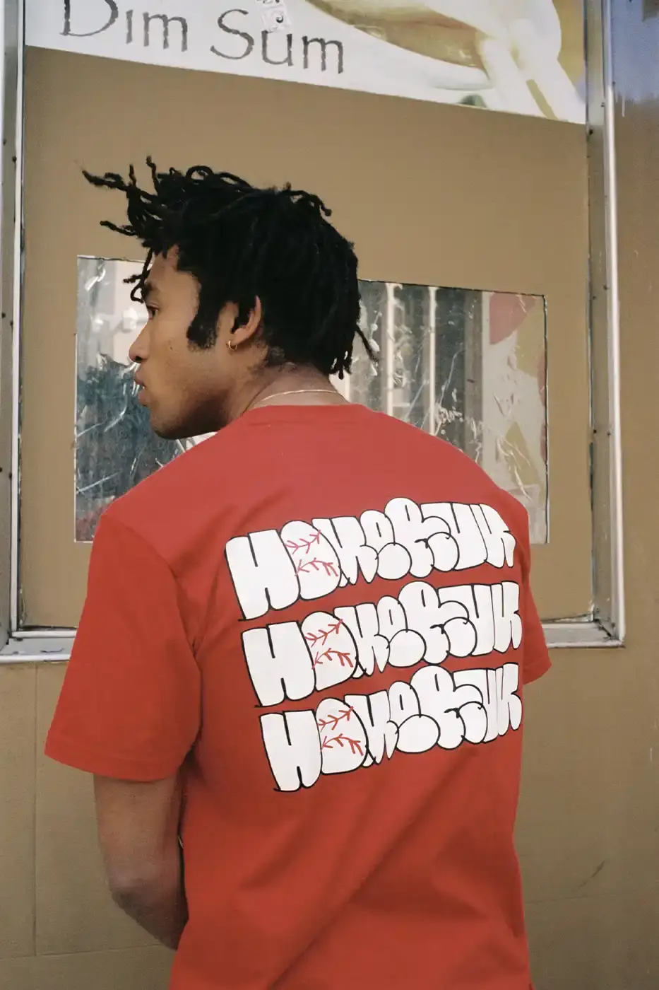 SUPREME PARTNERS WITH HOMERUN FOR BASEBALL-INSPIRED COLLECTION image of the Spring 2025 collaboration between Supreme and Homerun, a brand based in both New York City and Tokyo. The collection features baseball-inspired apparel including varsity jackets in silver and black, baseball jerseys in teal, navy, and pinstriped designs, plus hooded sweatshirts, t-shirts, and New Era caps. All items display co-branding with Homerun's cartoon graphics and "Non Stop" motto. The collection launches May 15 globally and May 17 in Asia through Supreme's website and stores. (image 12 of 14)