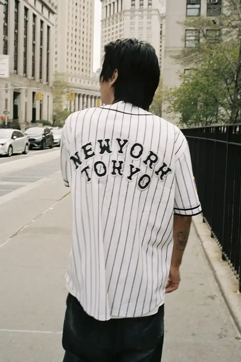 SUPREME PARTNERS WITH HOMERUN FOR BASEBALL-INSPIRED COLLECTION image of the Spring 2025 collaboration between Supreme and Homerun, a brand based in both New York City and Tokyo. The collection features baseball-inspired apparel including varsity jackets in silver and black, baseball jerseys in teal, navy, and pinstriped designs, plus hooded sweatshirts, t-shirts, and New Era caps. All items display co-branding with Homerun's cartoon graphics and "Non Stop" motto. The collection launches May 15 globally and May 17 in Asia through Supreme's website and stores. (image 10 of 14)