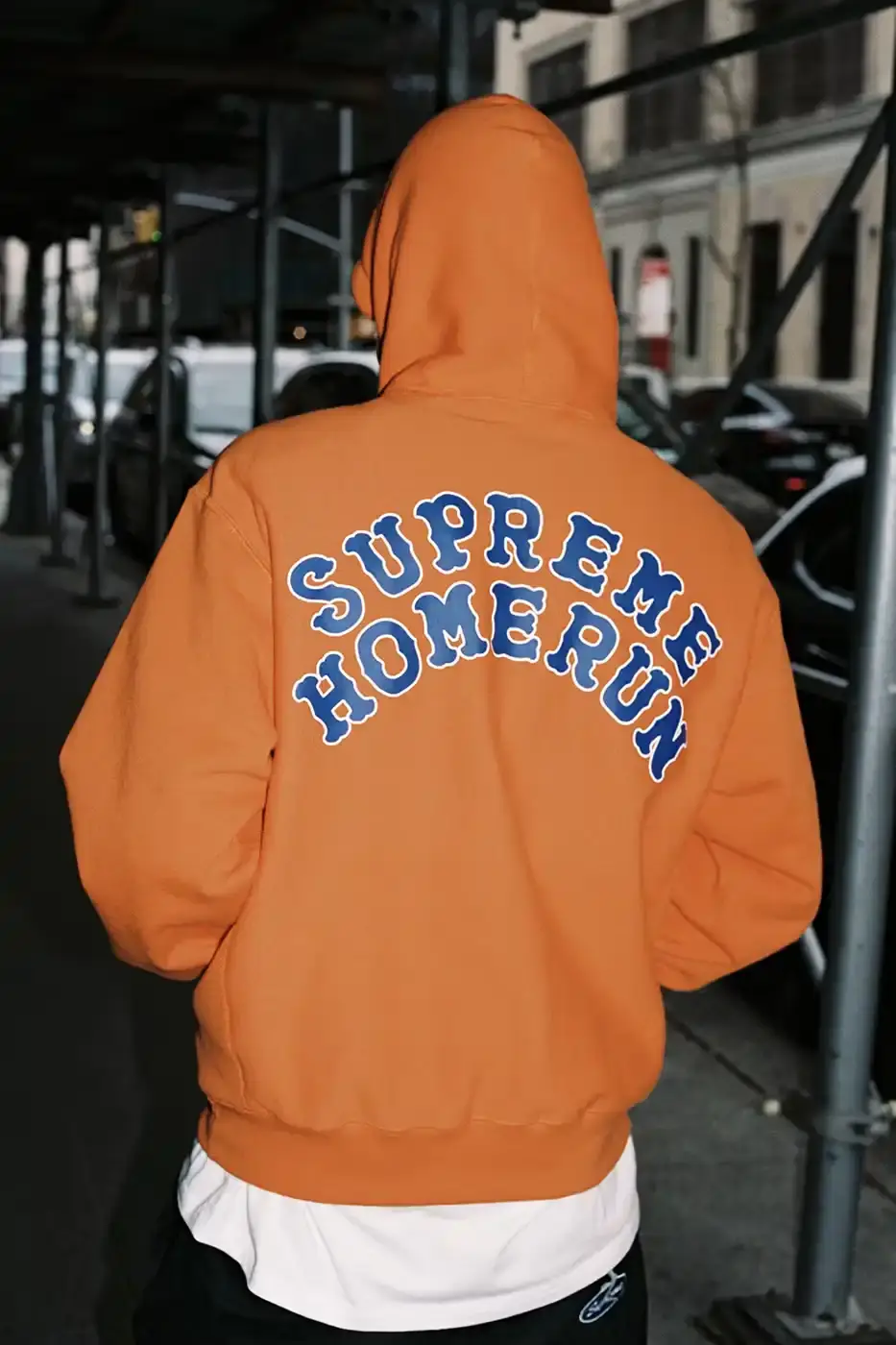 SUPREME PARTNERS WITH HOMERUN FOR BASEBALL-INSPIRED COLLECTION image of the Spring 2025 collaboration between Supreme and Homerun, a brand based in both New York City and Tokyo. The collection features baseball-inspired apparel including varsity jackets in silver and black, baseball jerseys in teal, navy, and pinstriped designs, plus hooded sweatshirts, t-shirts, and New Era caps. All items display co-branding with Homerun's cartoon graphics and "Non Stop" motto. The collection launches May 15 globally and May 17 in Asia through Supreme's website and stores. (image 4 of 14)