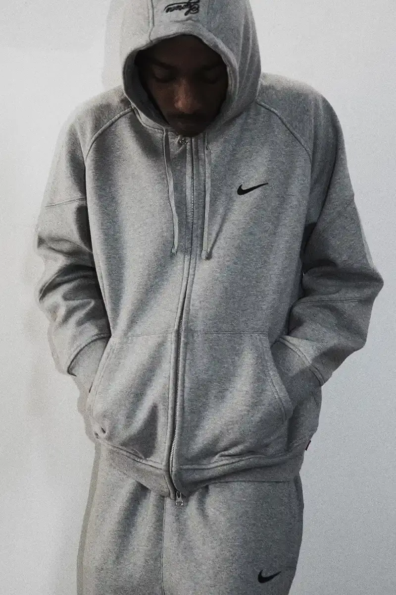 Supreme/Nike Supreme x Nike Spring 2025 Collection featuring black and white Leather Varsity Jackets, purple, yellow and black Track Suits, striped Rugby shirts, Sweater Vests, Hooded Sweatshirts, and accessories including Running Hats and Leather Shoulder Bags. (image 6 of 22)
