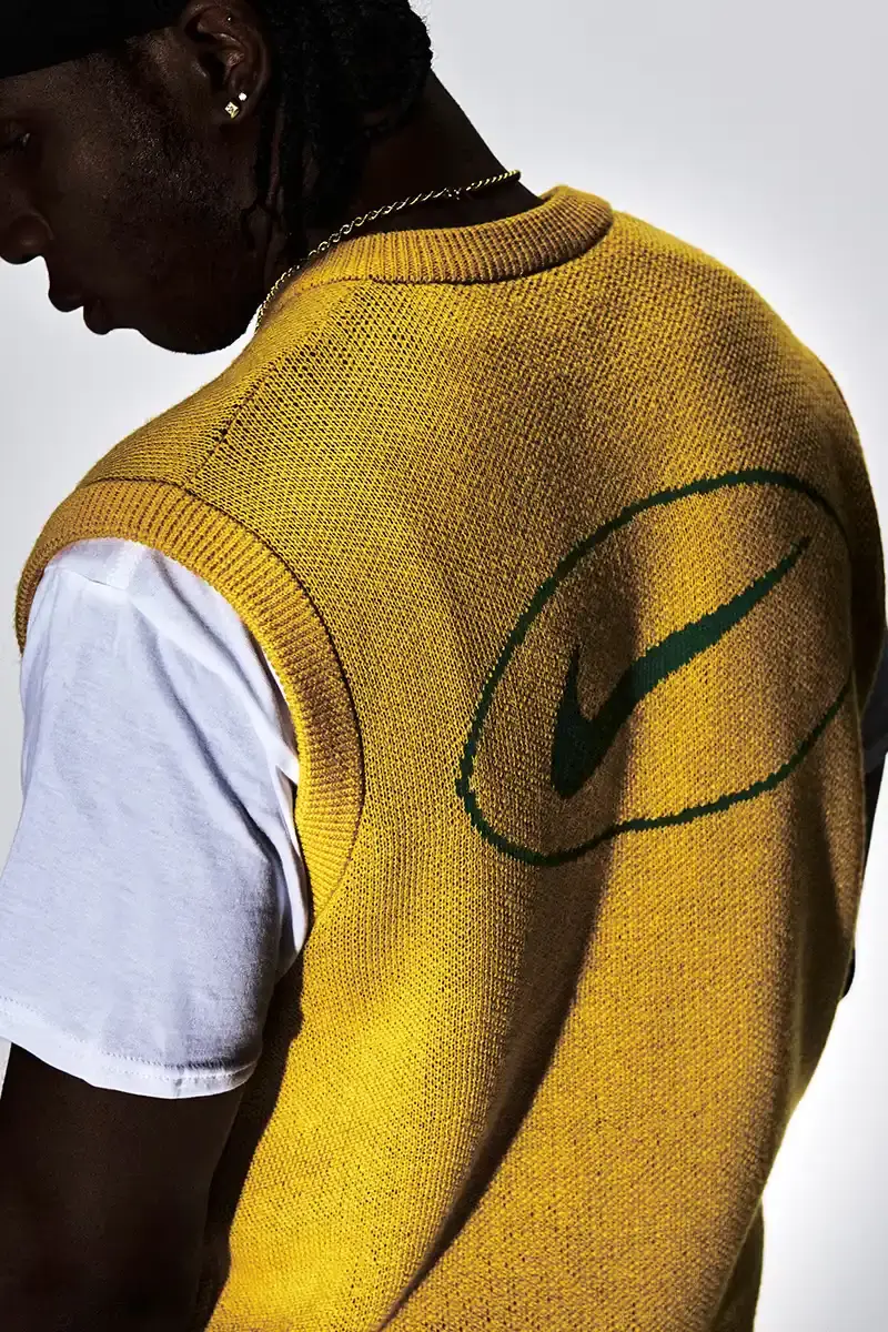 Supreme/Nike Supreme x Nike Spring 2025 Collection featuring black and white Leather Varsity Jackets, purple, yellow and black Track Suits, striped Rugby shirts, Sweater Vests, Hooded Sweatshirts, and accessories including Running Hats and Leather Shoulder Bags. (image 9 of 22)