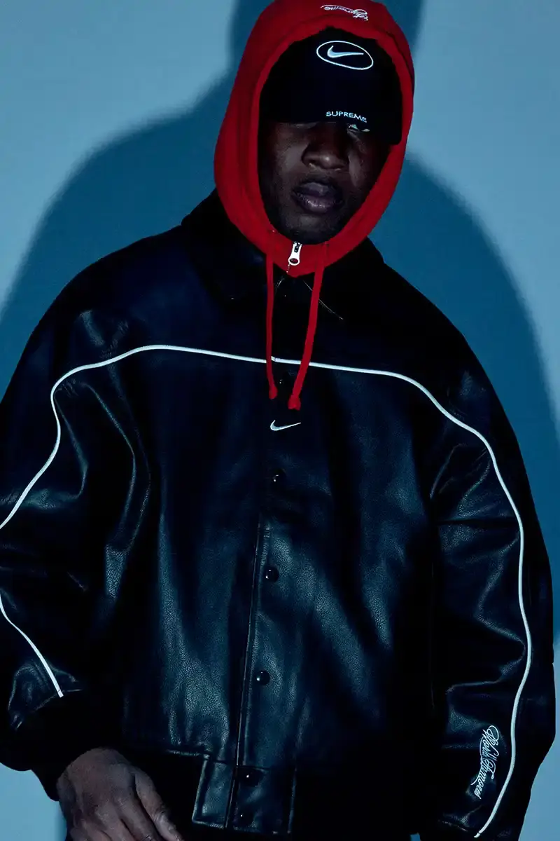 Supreme/Nike Supreme x Nike Spring 2025 Collection featuring black and white Leather Varsity Jackets, purple, yellow and black Track Suits, striped Rugby shirts, Sweater Vests, Hooded Sweatshirts, and accessories including Running Hats and Leather Shoulder Bags.