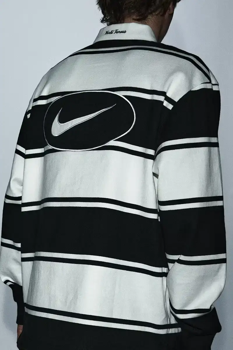Supreme/Nike Supreme x Nike Spring 2025 Collection featuring black and white Leather Varsity Jackets, purple, yellow and black Track Suits, striped Rugby shirts, Sweater Vests, Hooded Sweatshirts, and accessories including Running Hats and Leather Shoulder Bags. (image 12 of 22)
