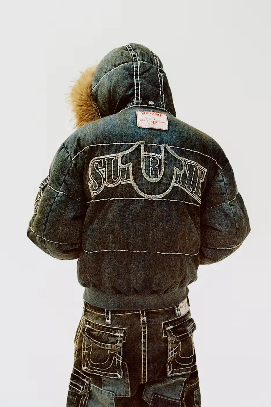 SUPREME TEAMS WITH TRUE RELIGION FOR FALL 2025 Supreme and True Religion announce a Fall 2025 collaboration featuring denim and leather outerwear, hoodies, accessories, and signature horseshoe logo details, releasing November 20, 2025. (image 14 of 15)
