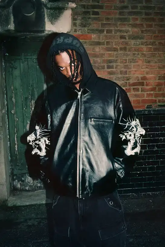 SUPREME X Y'S YAMAMOTO FALL 2025 COLLECTION Fashion collaboration image describing Supreme and Y's by Yohji Yamamoto Fall 2025 collection featuring punk aesthetics and skull designs. (image 19 of 20)