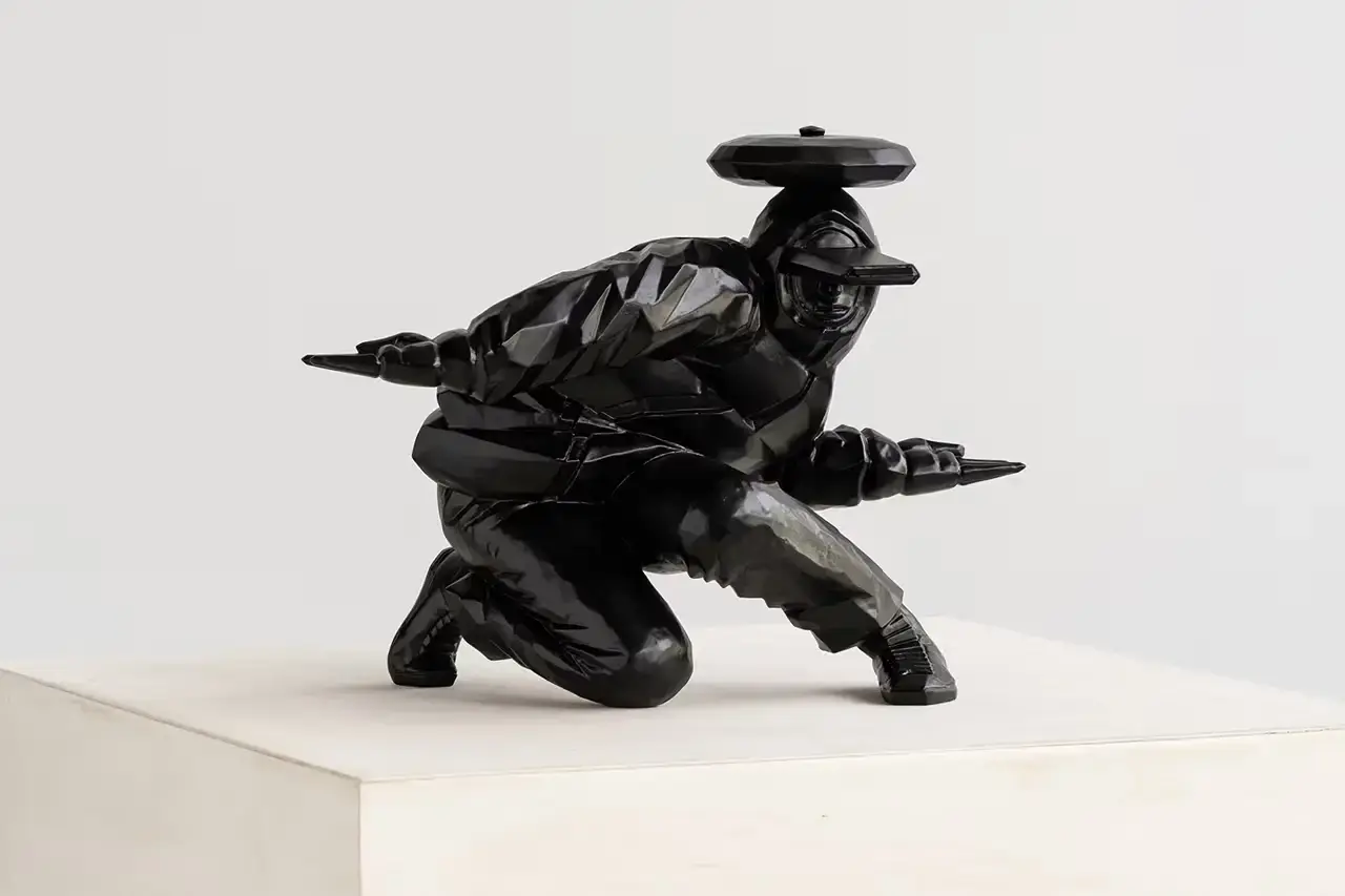 TAKU OBATA'S 'B BOY SEIDOU': WHERE BREAKDANCING MEETS BRONZE Japanese artist Taku Obata unveils ‘B BOY SEIDOU’, a limited edition bronze sculpture in collaboration with London’s Avant Arte studio. The sculpture captures the essence of breakdancing, translating dynamic street dance movements into a static yet powerful form. Obata, both an artist and breakdancer, portrays a dancer frozen mid-motion with limbs stretched outward, wearing an oversized hat. This piece marks Obata’s shift from wooden sculptures to bronze casting, featuring a matte black finish. Measuring 10.6 x 8.2 x 7.8 inches, ‘B BOY SEIDOU’ engages viewers with its outward gaze, reflecting the performative nature of breakdancing. Limited to 25 pieces, each sculpture comes with a certificate of authenticity and is priced at $6,815. The acquisition process involves a raffle system closing on October 1 at 9 am ET. Obata’s work bridges street dance and fine art, challenging artistic boundaries
