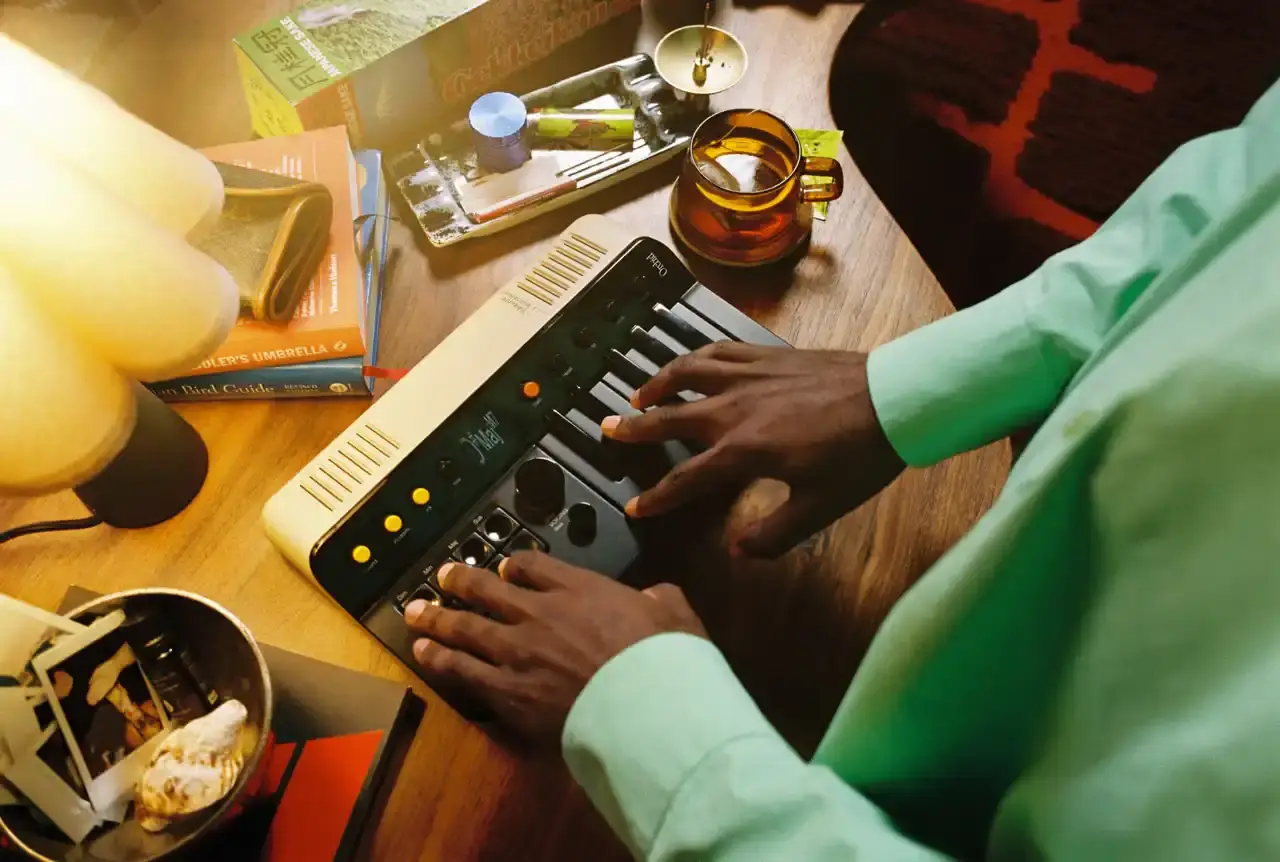 Telepathic Instruments Image of The Orchid, a portable digital synthesizer with a sleek design, featuring multiple control buttons and a keyboard interface. Created by Tame Impala's Kevin Parker through Telepathic Instruments. (image 4 of 6)