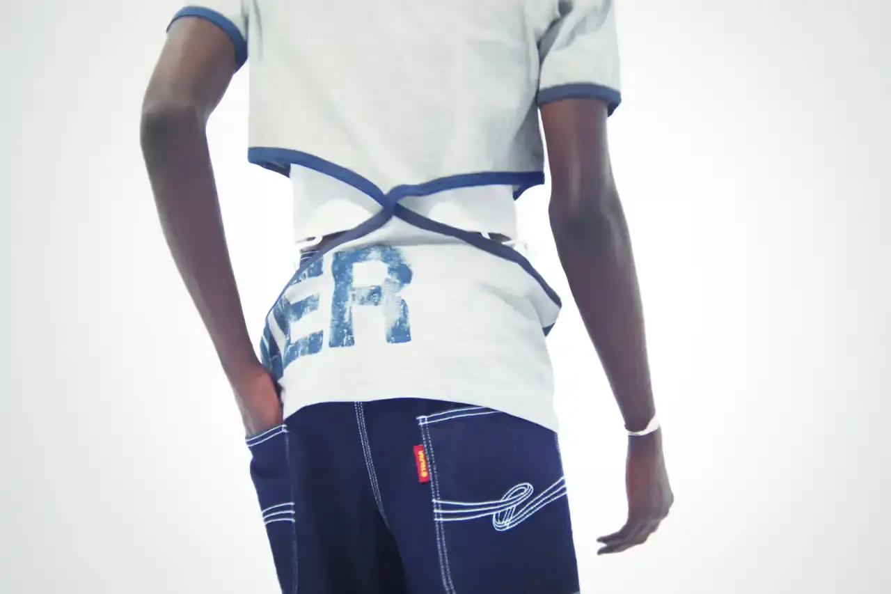TELFAR LAUNCHES EXPANSIVE DENIM COLLECTION IN SOHO Telfar's new Infinity Collection, highlighting the brand's innovative approach to denim design. The collection features versatile, unisex garments with transformative silhouettes, priced between $190-$485. Key points include multipurpose clothing, unique cut-out designs, and an unconventional retail strategy at the Soho flagship store. The text provides detailed information about the collection's aesthetic, pricing, and availability for readers using screen readers or assistive technologies. (image 10 of 20)